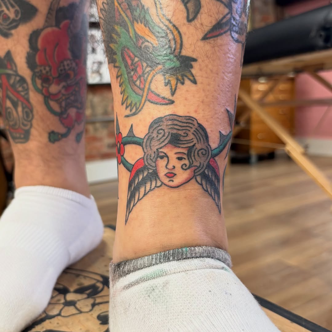Angel American traditional tattoo on the forearm by Izzy