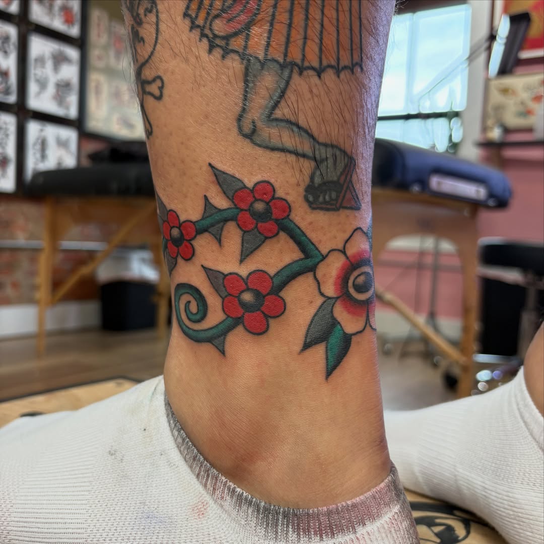 Flower vine American traditional tattoo on the forearm by Izzy