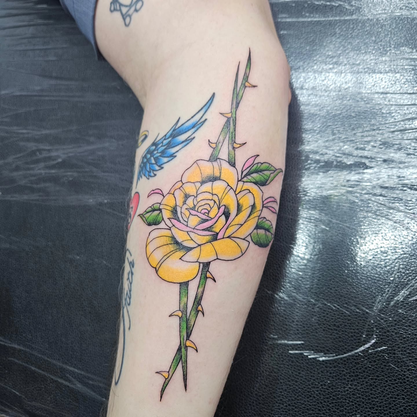 Yellow rose American traditional tattoo on the forearm by Danny