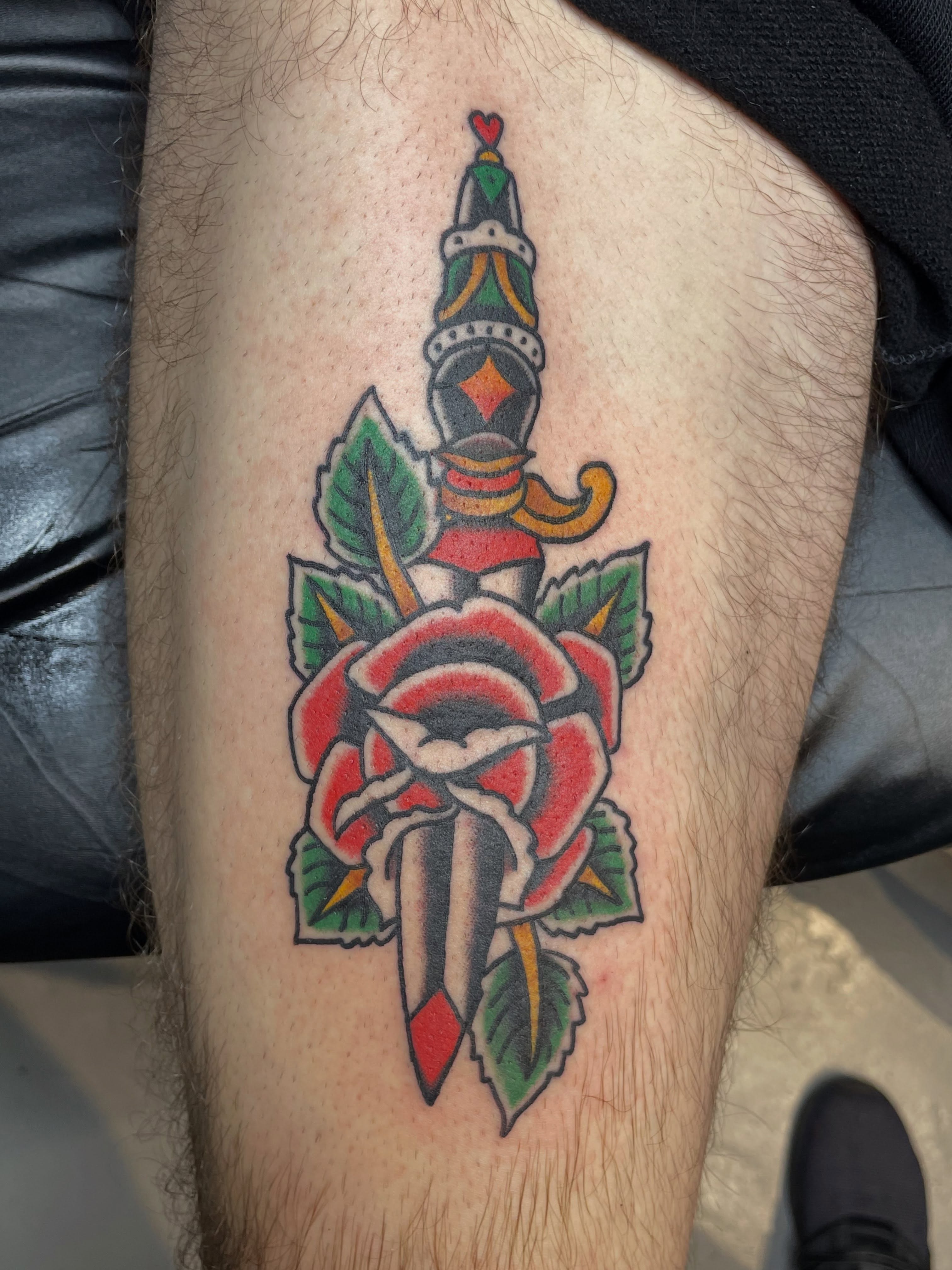 Rose and dagger American traditional tattoo on the thigh by Mitchell Willard