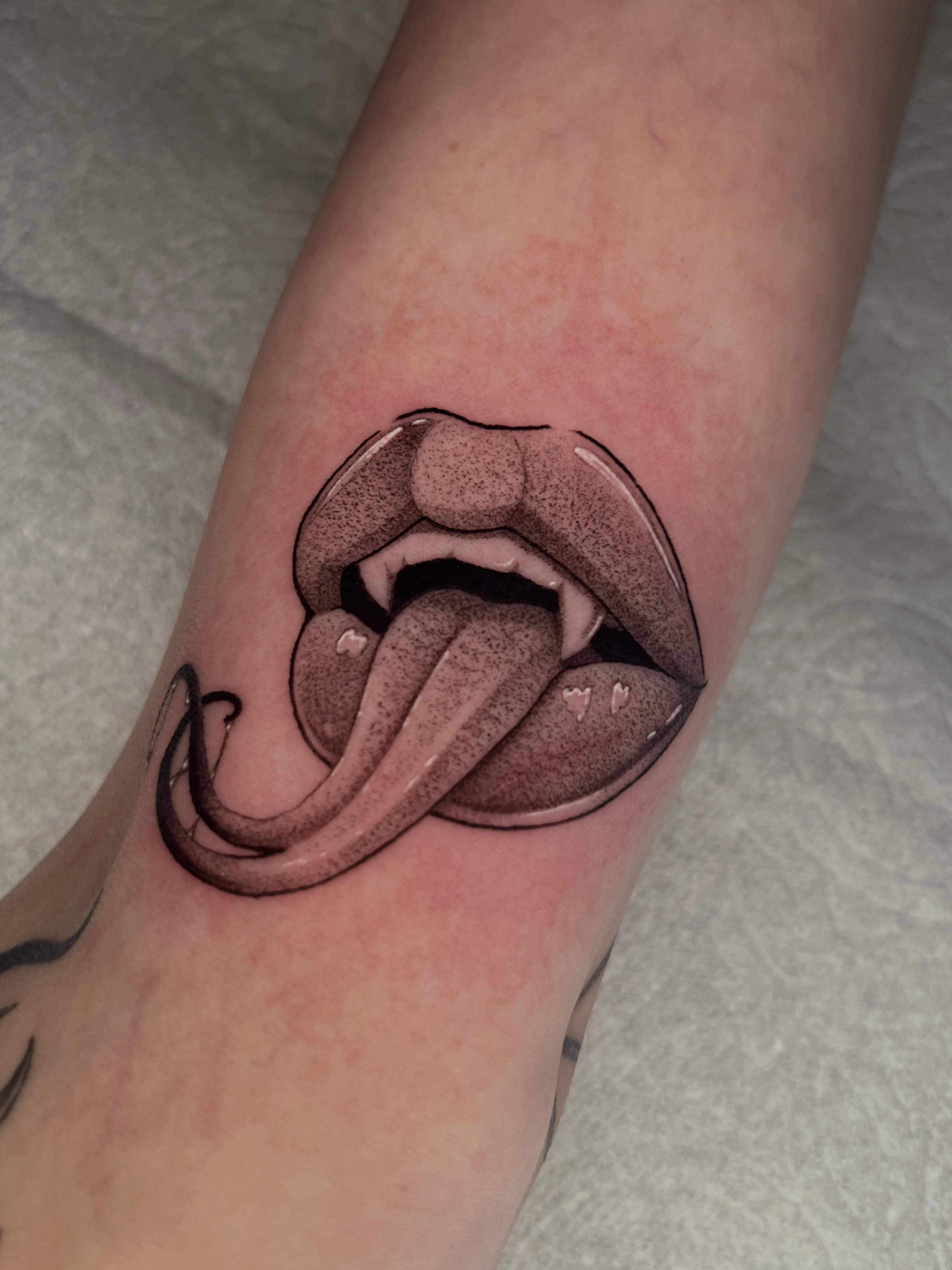 Open mouth with tongue dotwork tattoo on the forearm by Odi ✮⋆˙, Las Vegas, Nevada