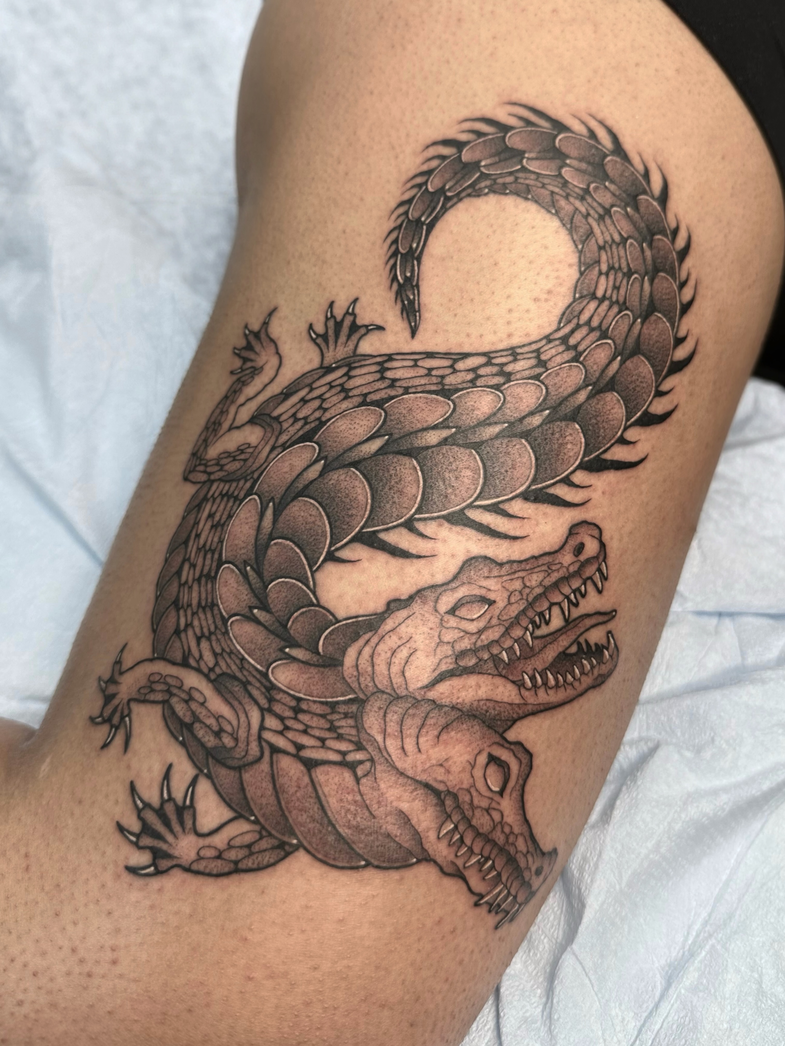 Dragon black and grey tattoo on the thigh by Brooklyn Bailey