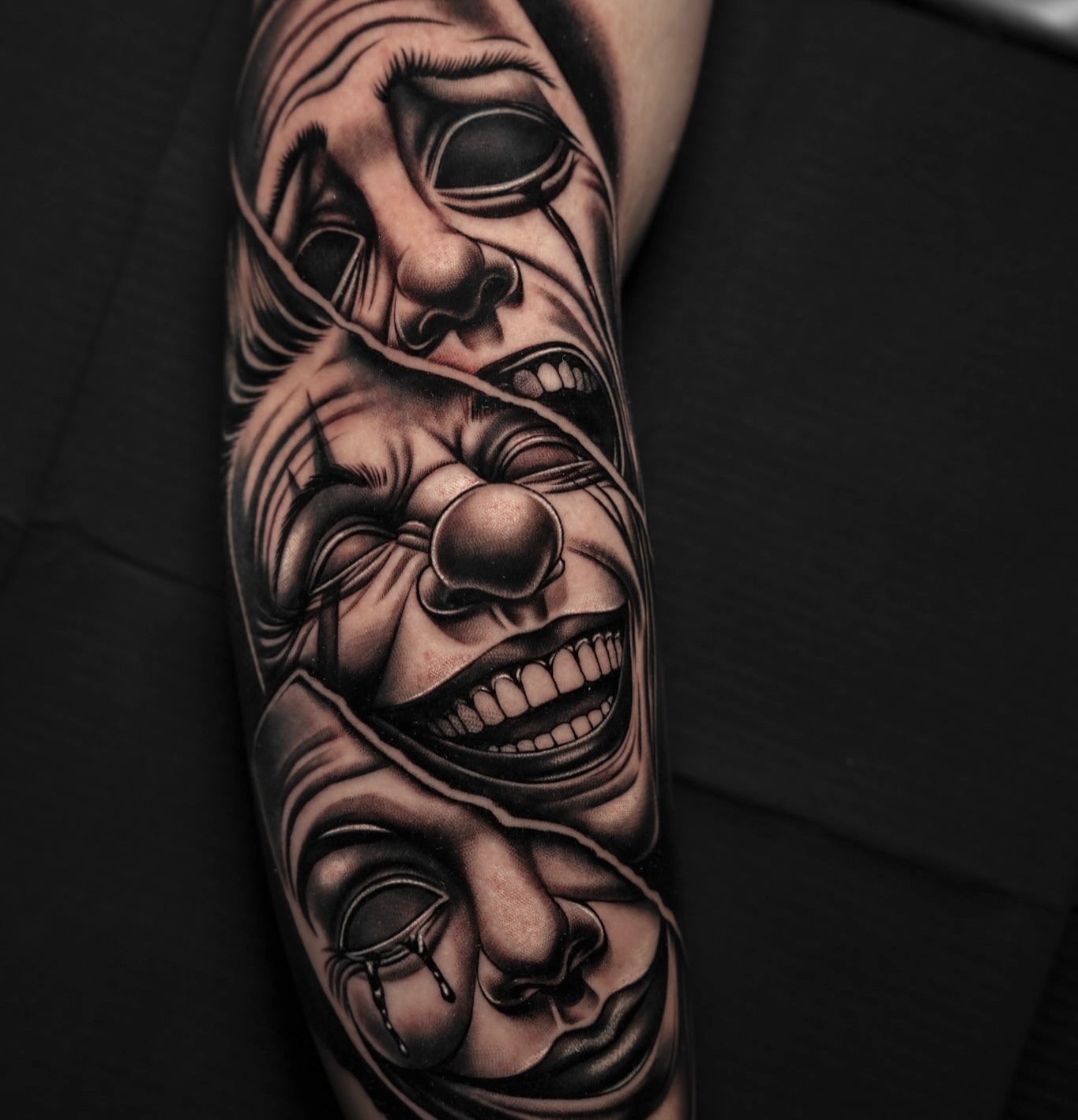 Clown faces realism tattoo on the forearm by Andy Garcia
