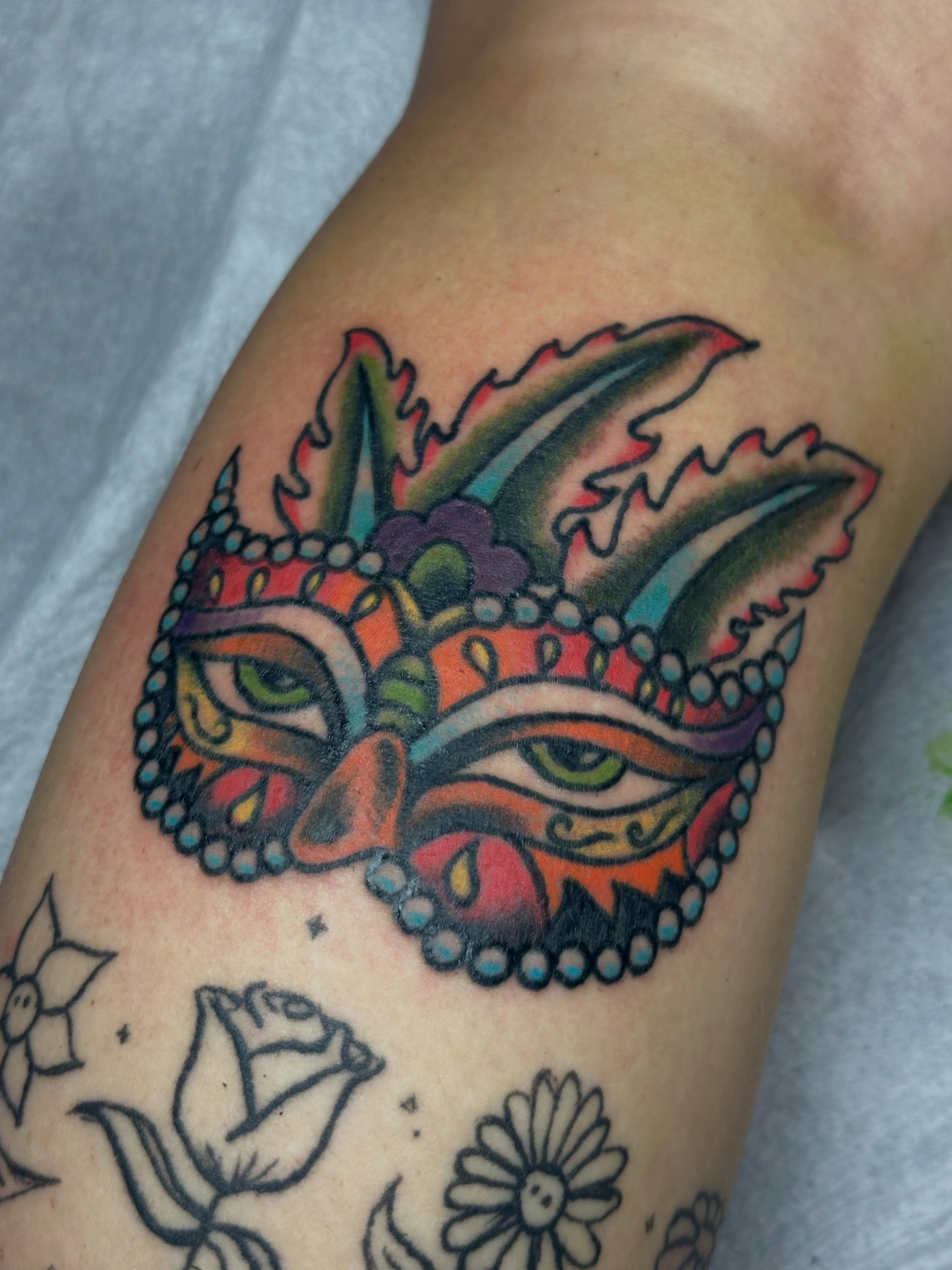 Mask American traditional tattoo on the forearm by Providence Tattooer