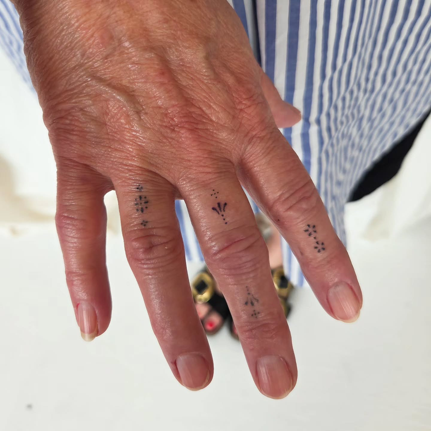 Finger tattoos dotwork tattoo on the hand by jules tattoos