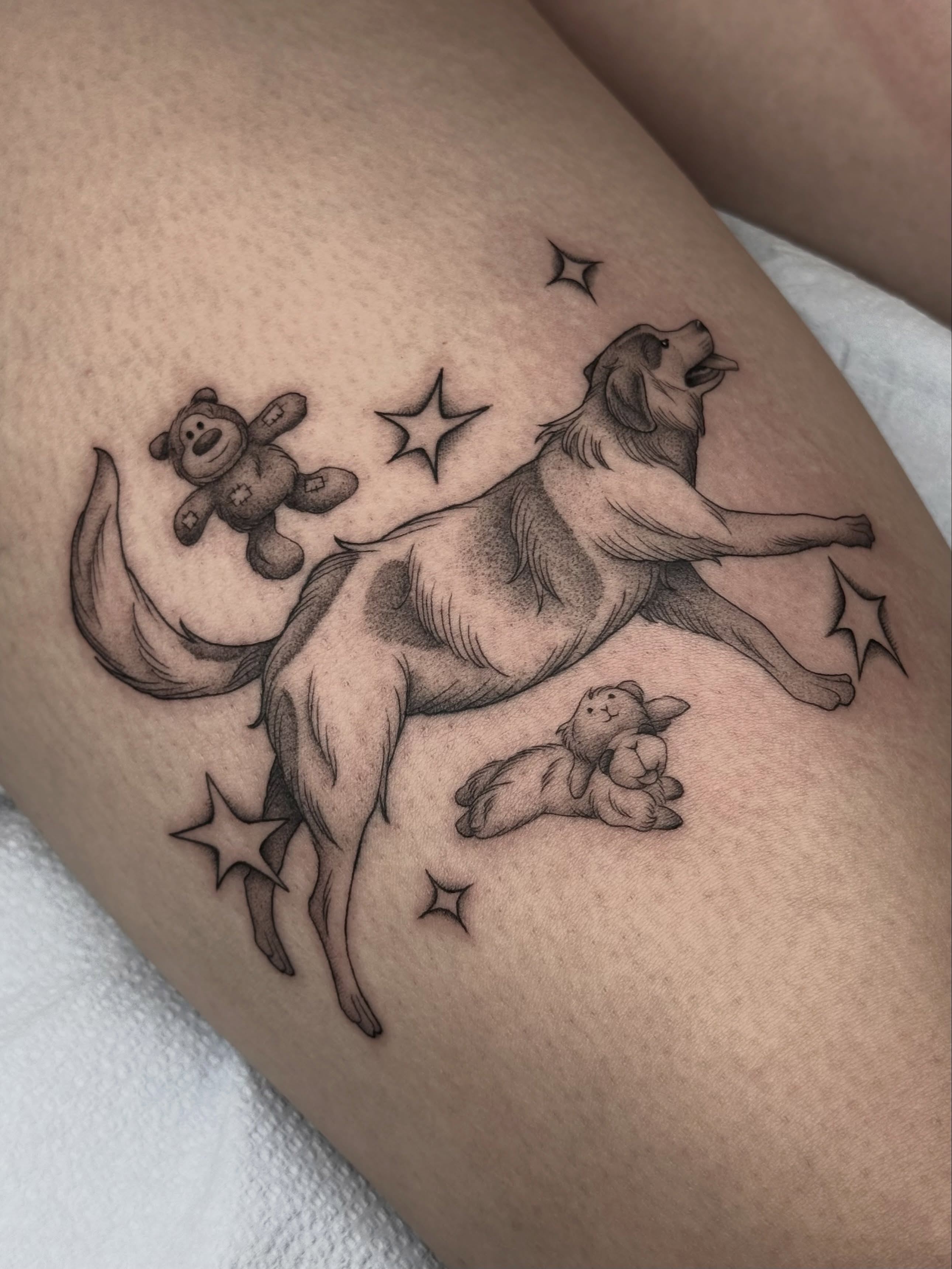 Dog with stars black and grey tattoo on the thigh by Carlos Abad