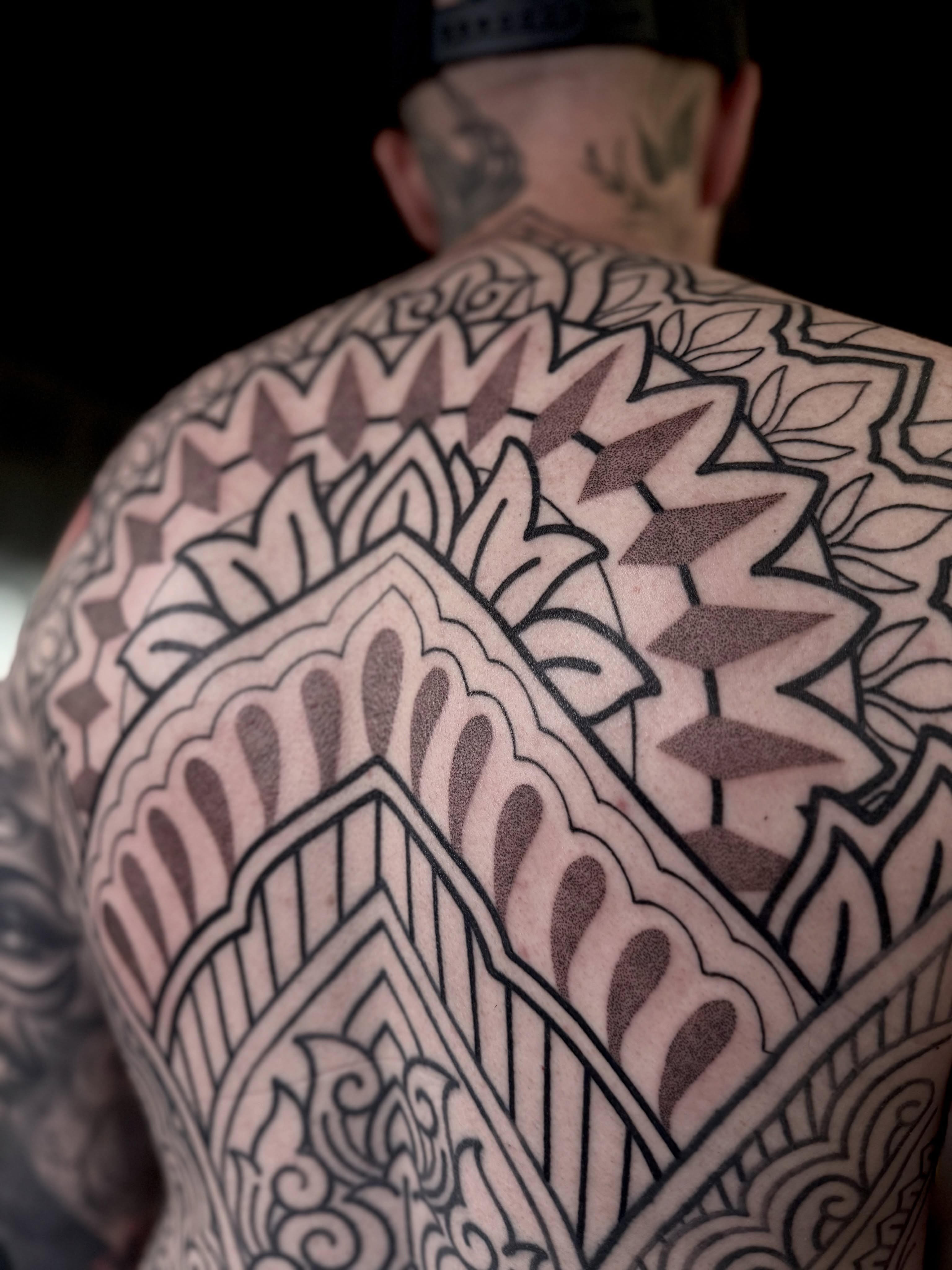 Geometric pattern geometric tattoo on the back by Haley Corinne