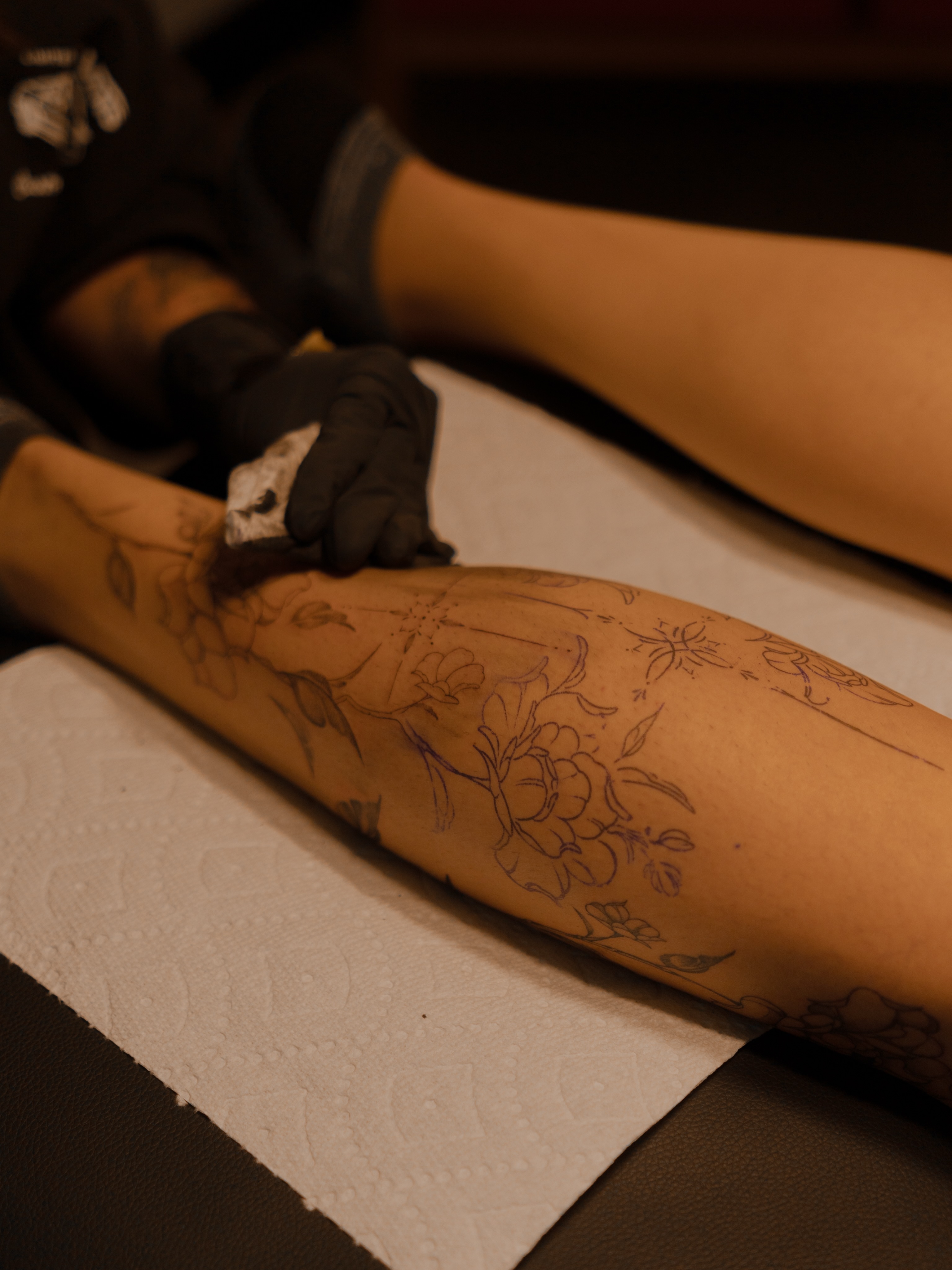 Floral design black and grey tattoo on the leg by Jen- San Antonio tattoo artist