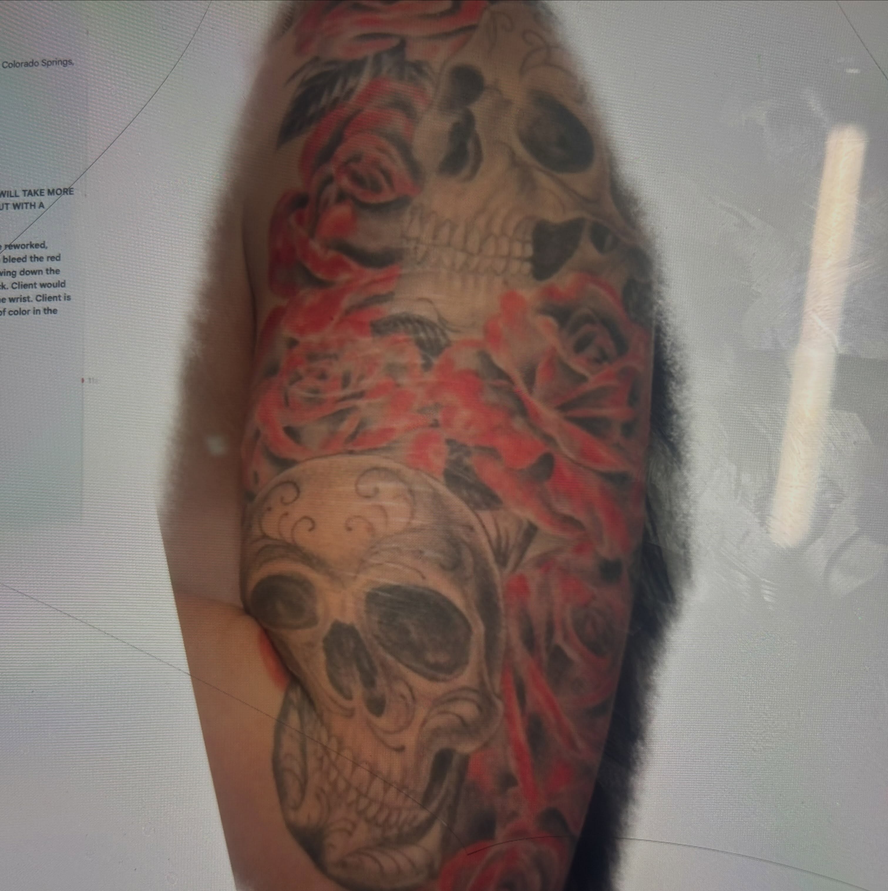 Skulls and roses American traditional tattoo on the forearm by Jamie Winn
