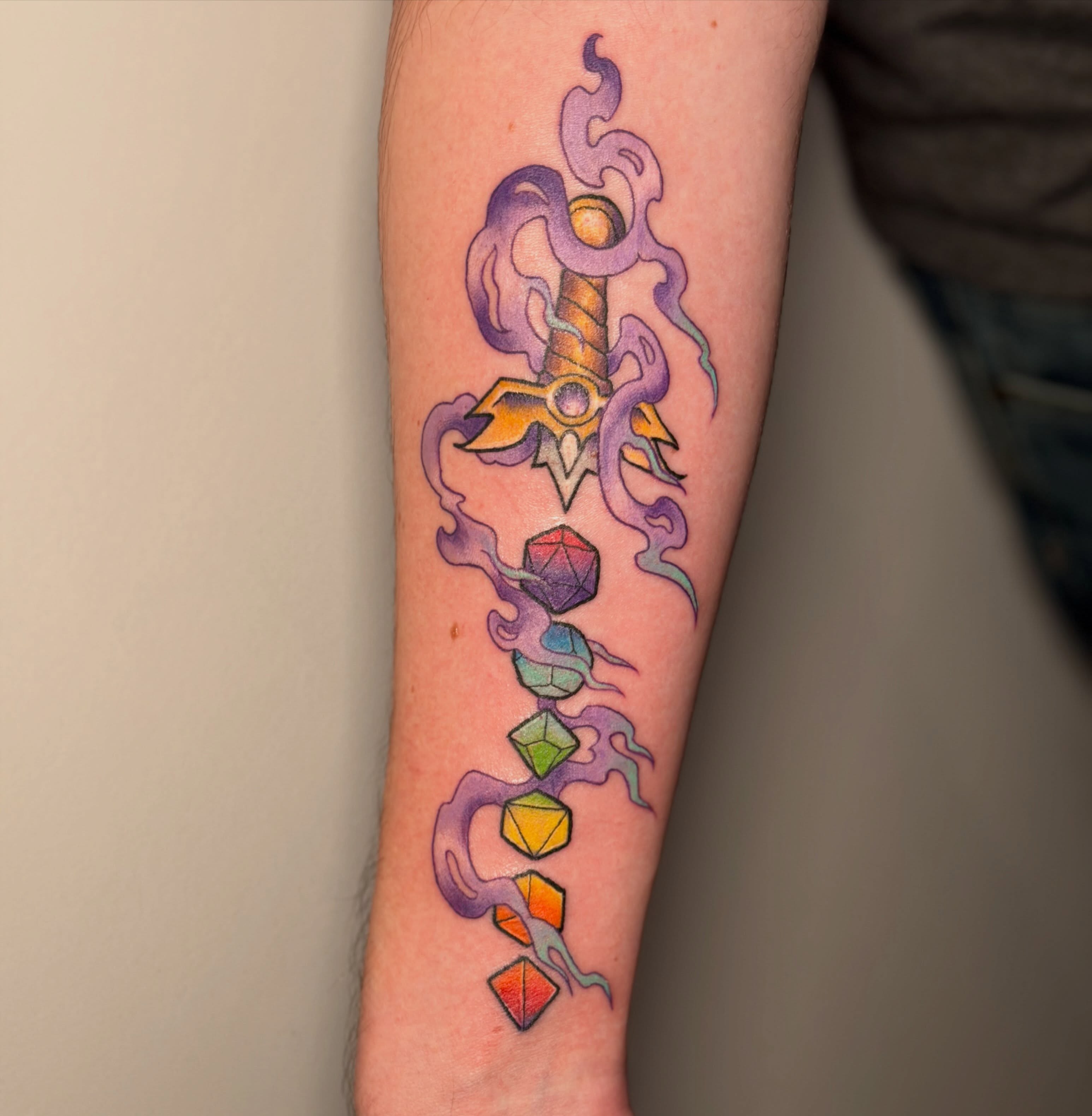 Sword and gemstones geometric tattoo on the forearm by Bry