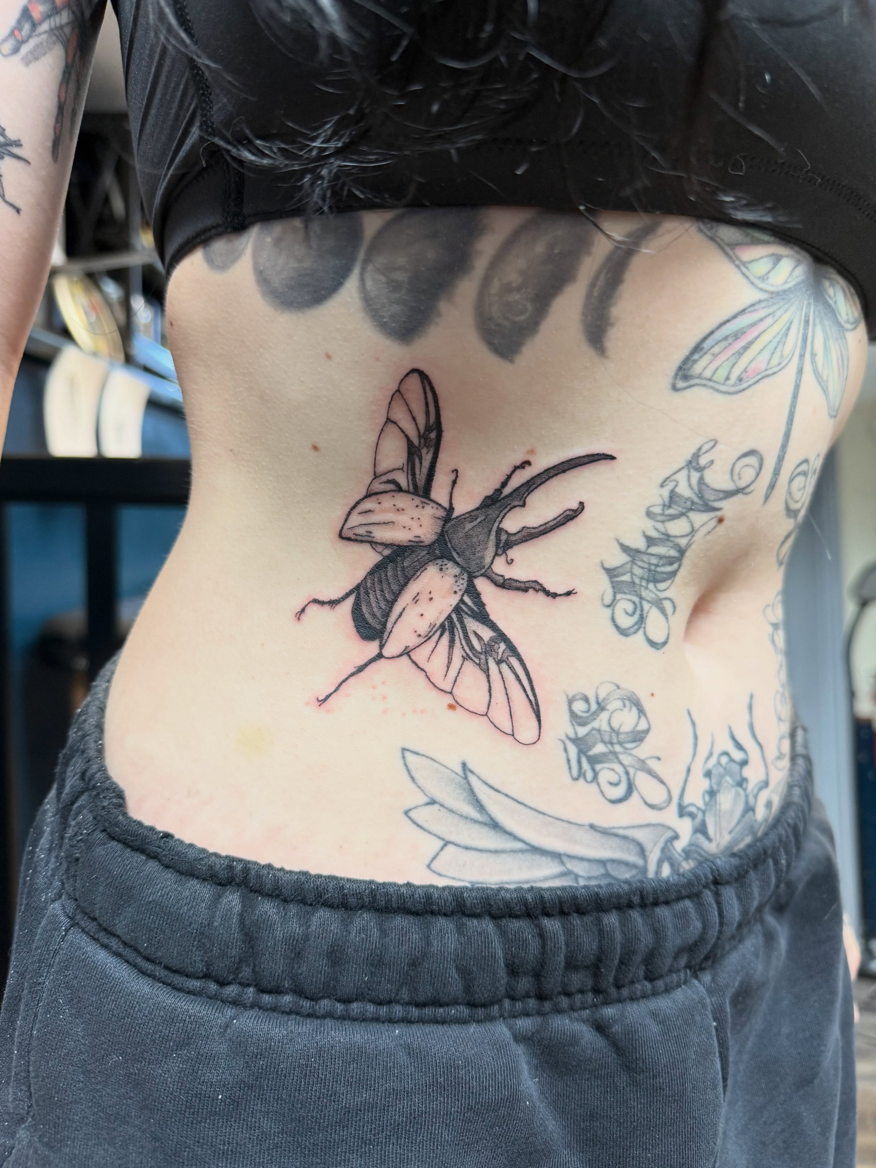 Beetle realism tattoo on the torso by Elena
