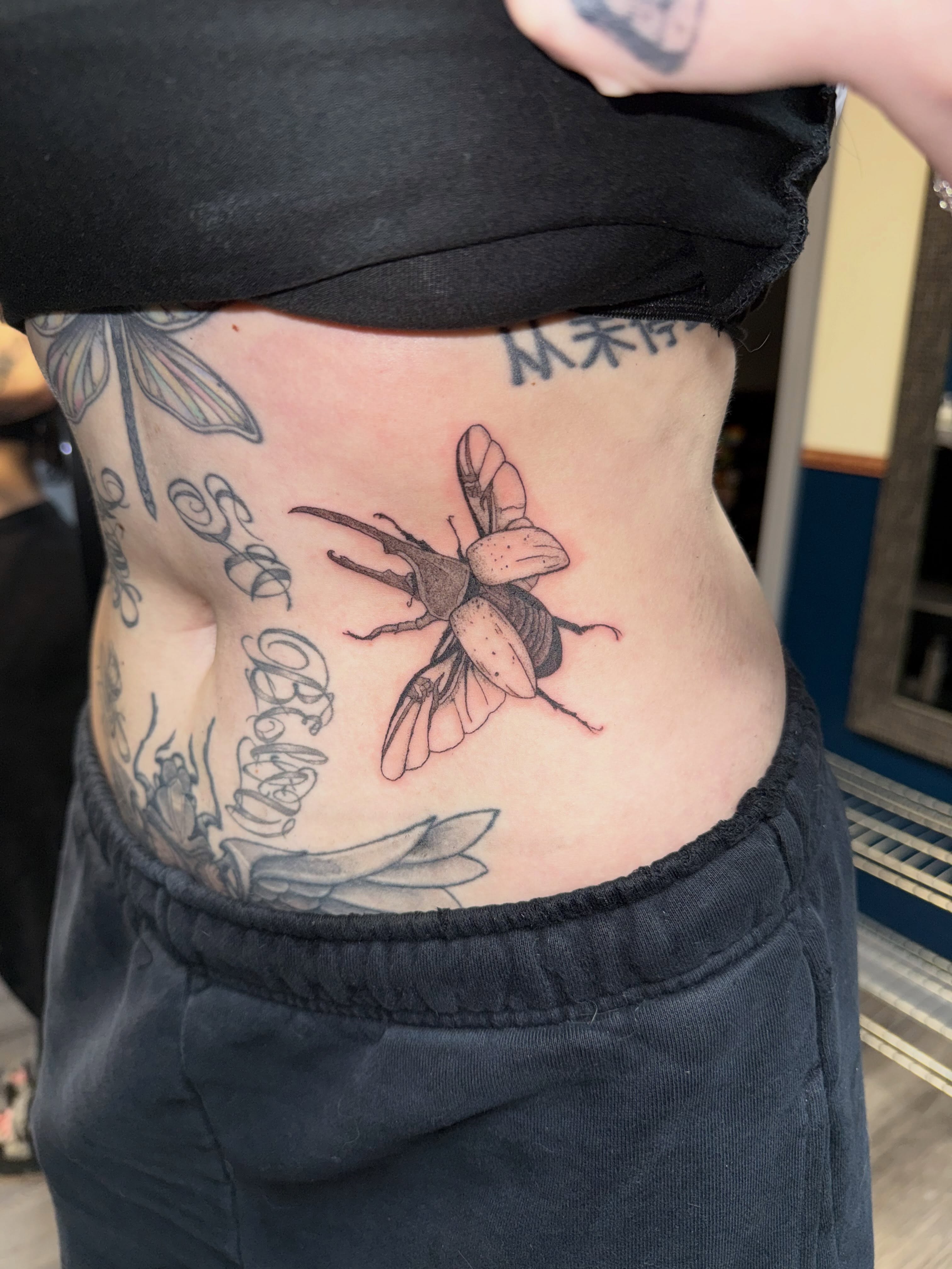 Beetle realism tattoo on the ribs by Elena