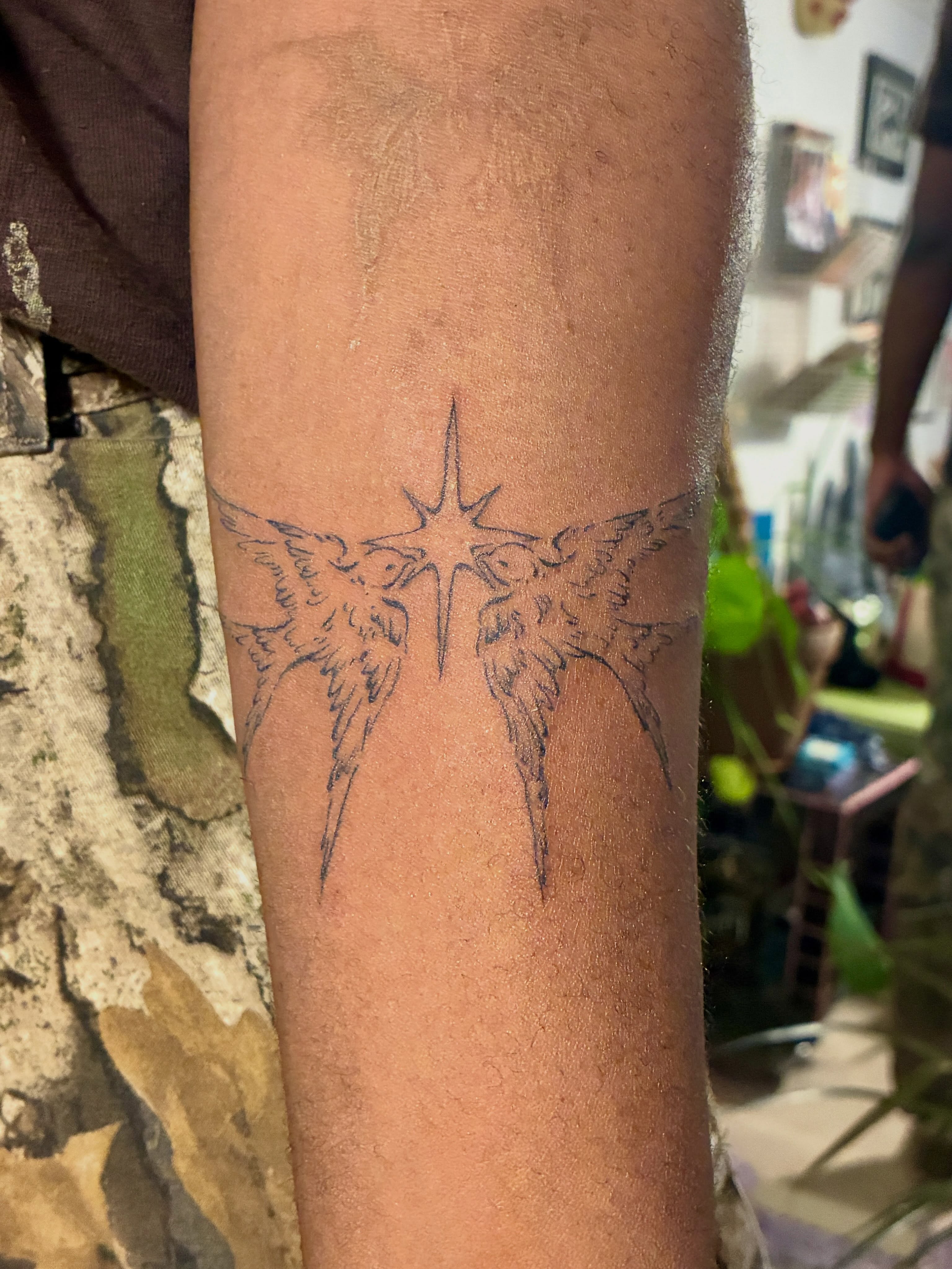 Angel wings geometric tattoo on the forearm by thalia