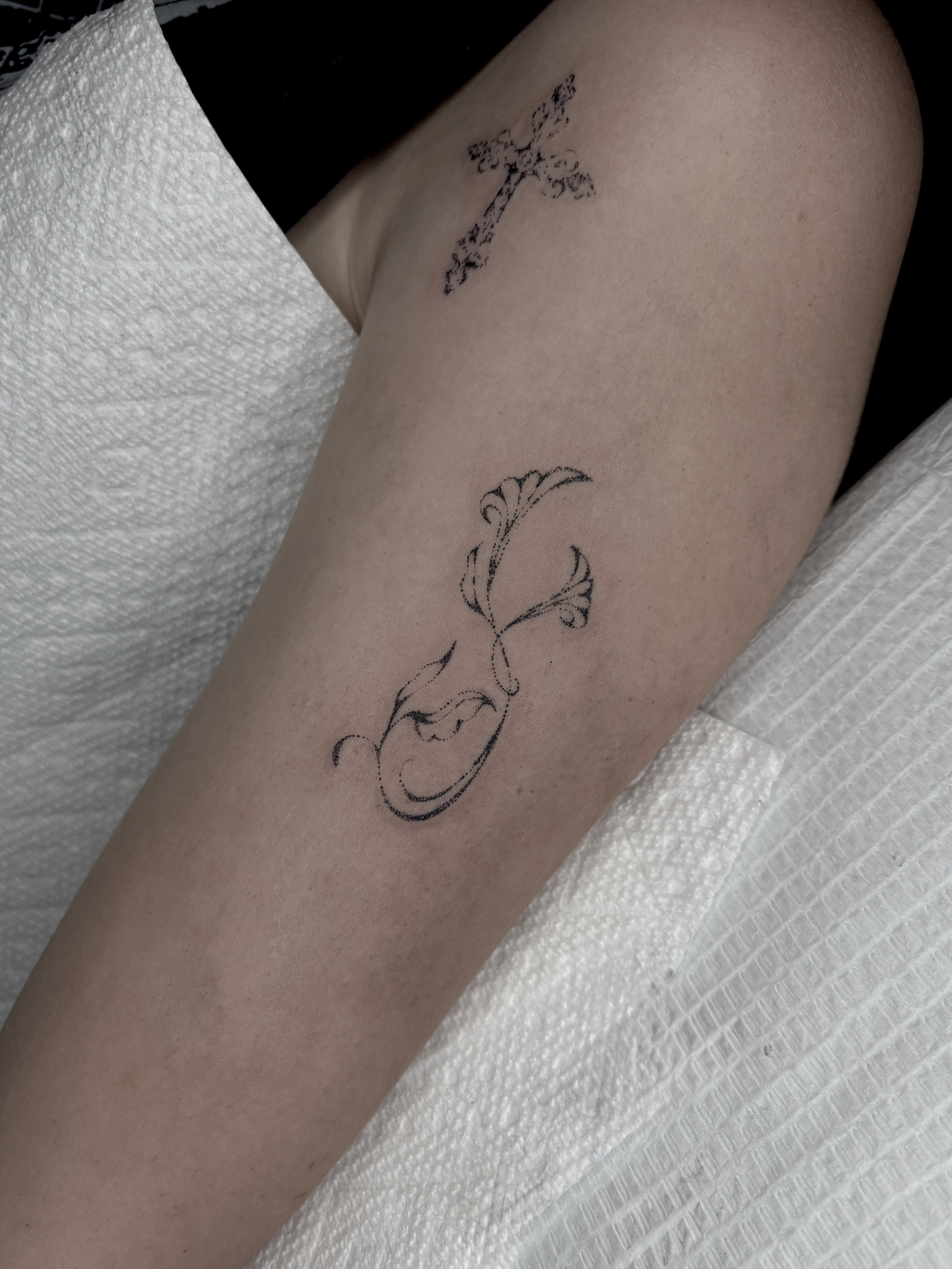 Deer and floral fine line tattoo on the forearm by Harlee Hornsby