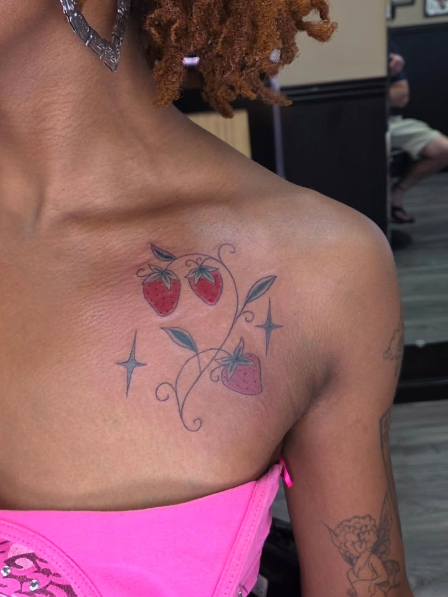 Strawberries and vines new school tattoo on the shoulder by Jessica Duggan
