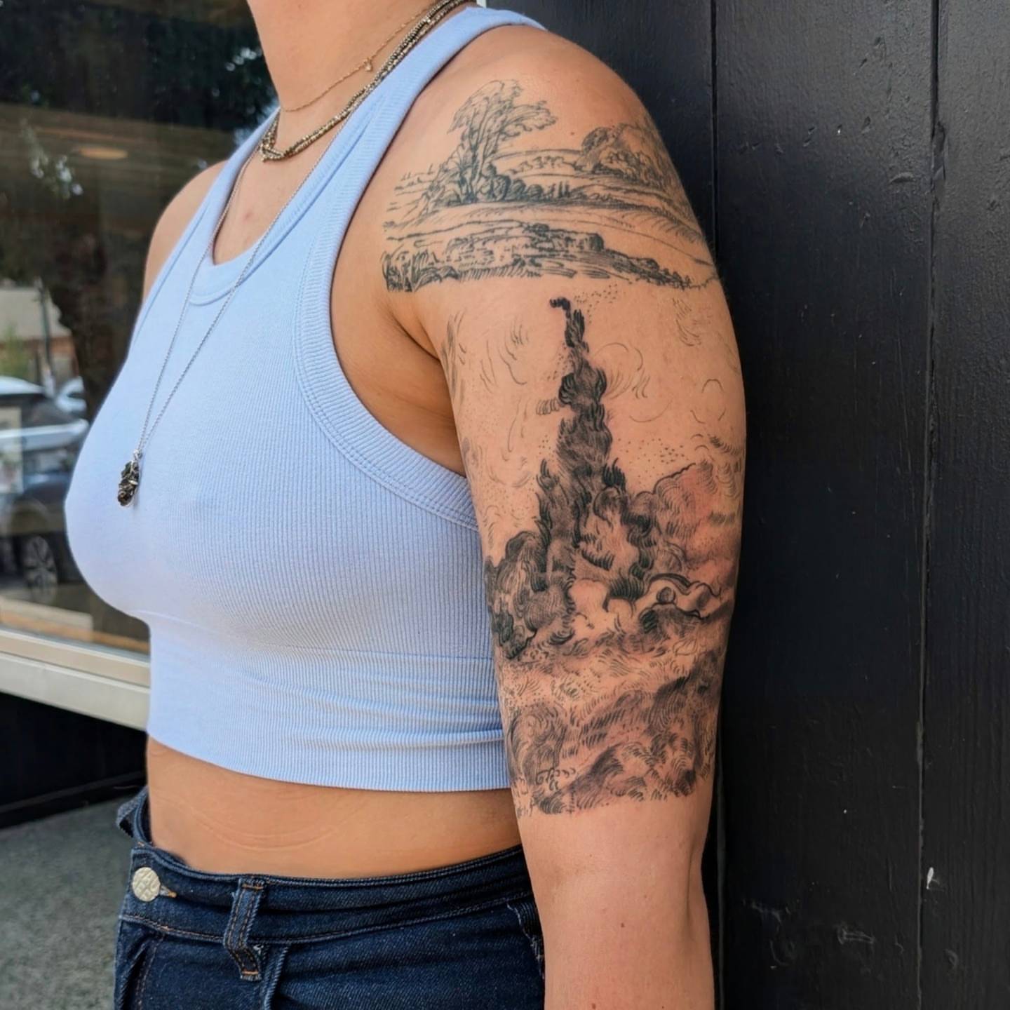 Landscape realism tattoo on the upper arm by Jhenn