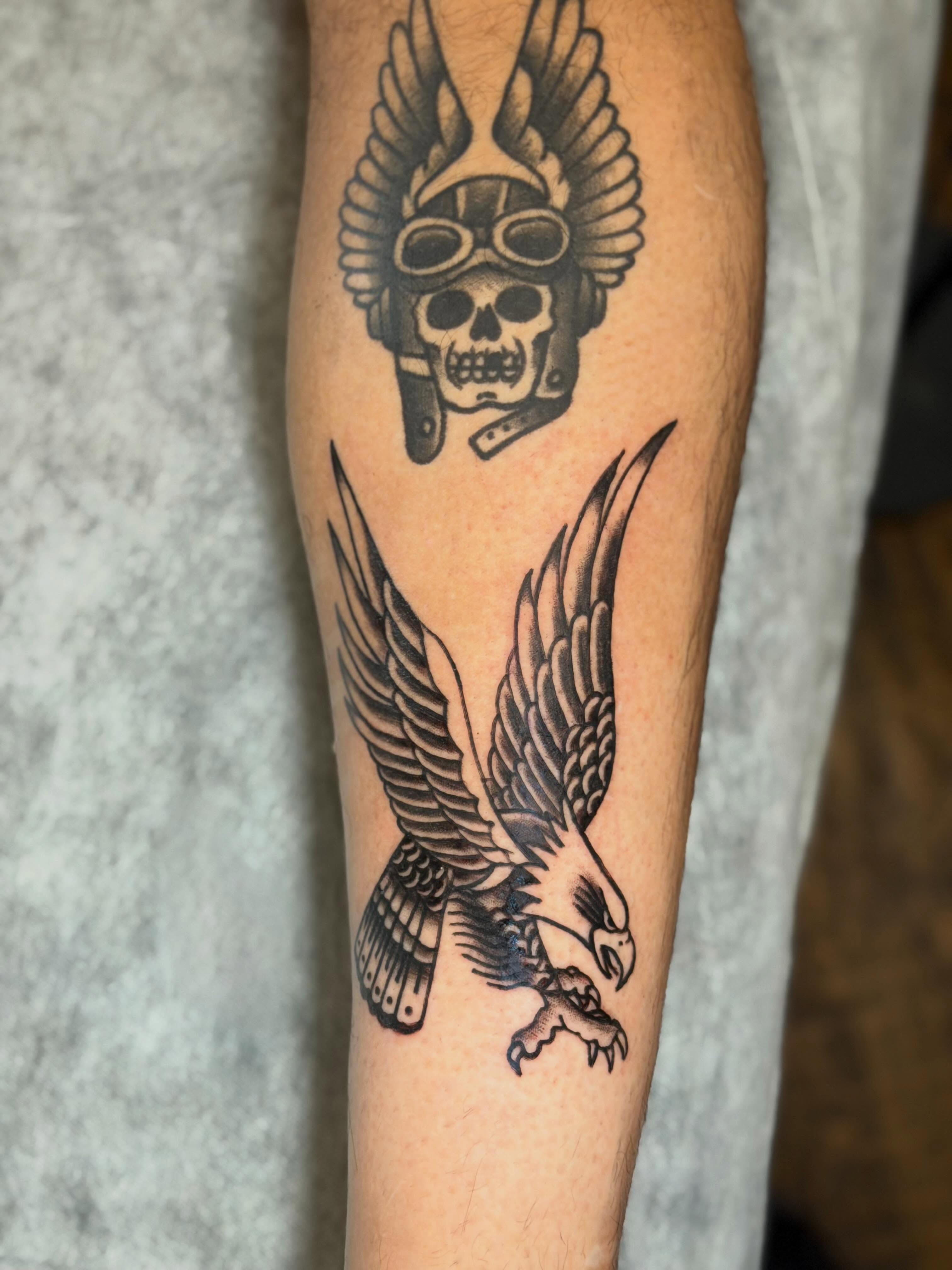 Eagle and skull black and grey tattoo on the forearm by C.J.K. Roy