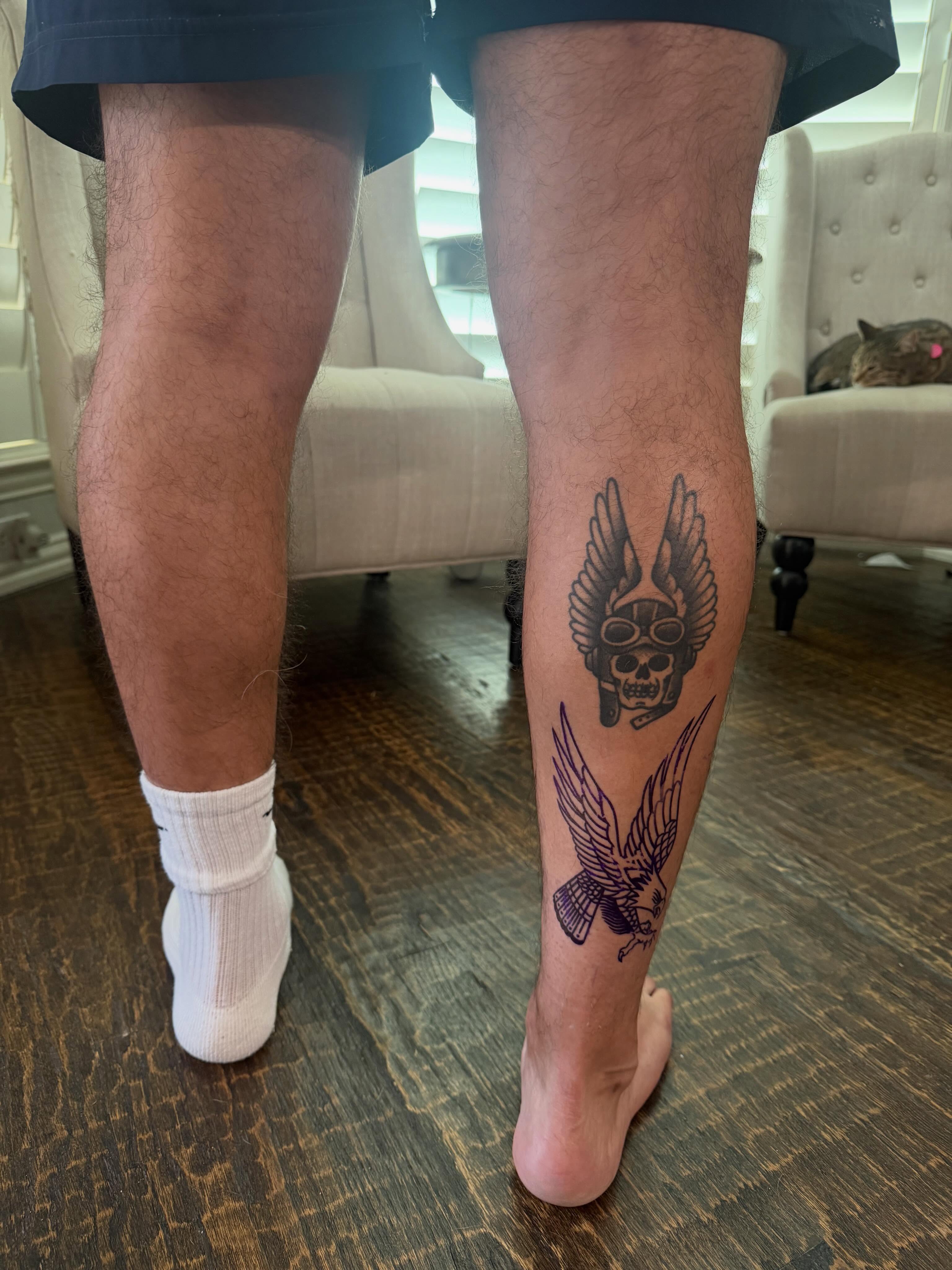 Skull with wings black and grey tattoo on the calf by C.J.K. Roy