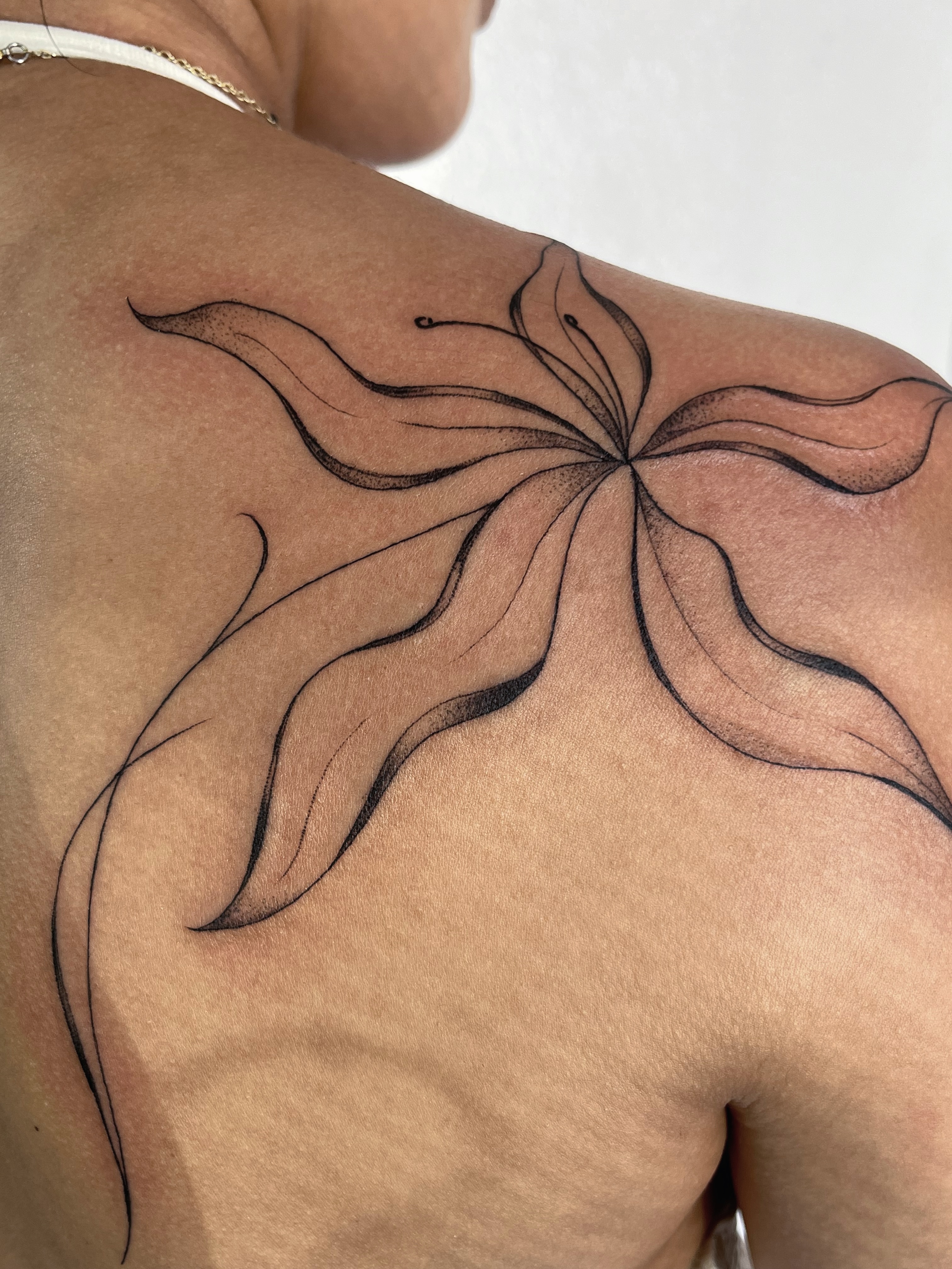 Abstract flower black and grey tattoo on the back by Sara Atamian, San Diego, California