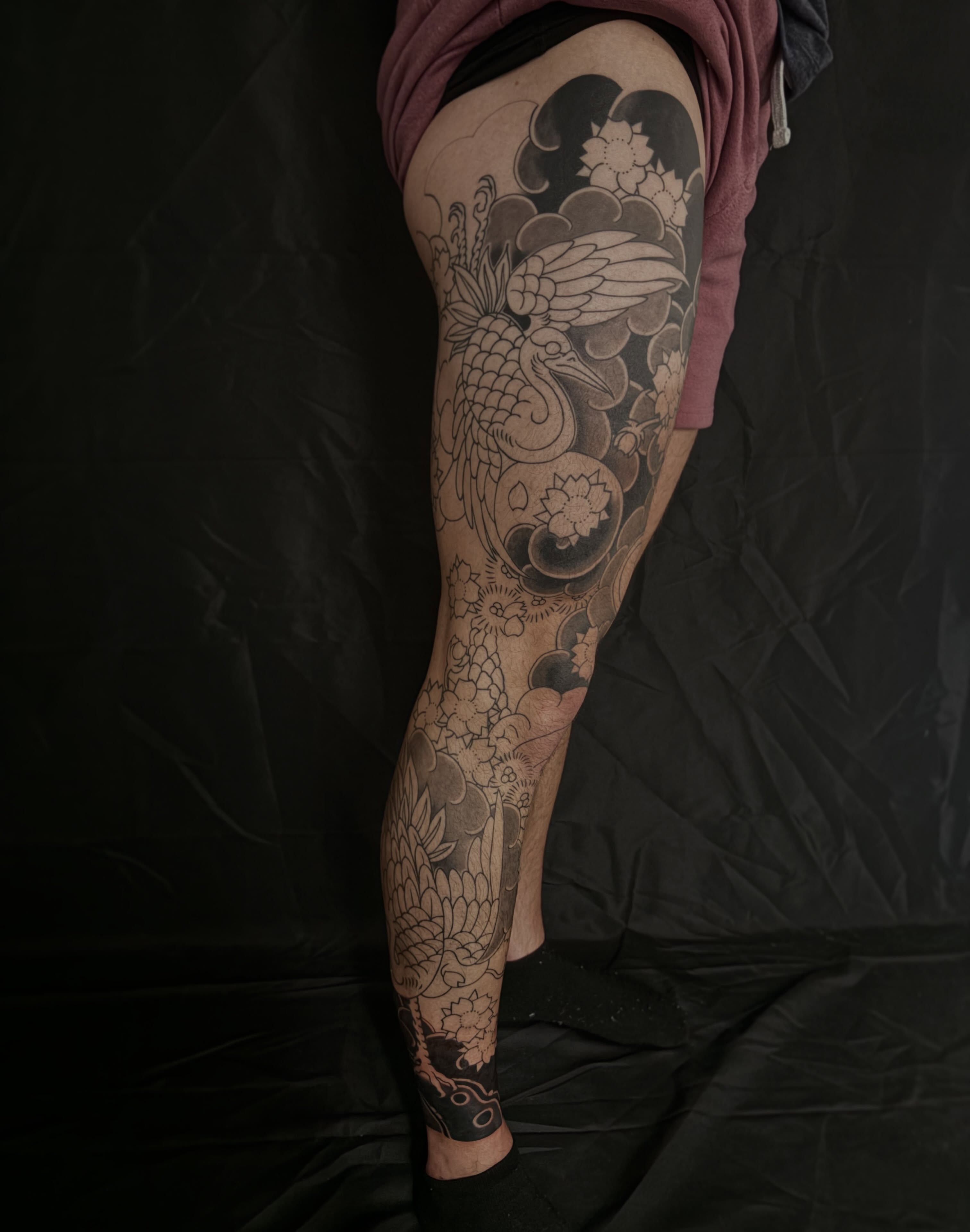 Koi fish and floral black and grey tattoo on the leg by Zach Hendrickson