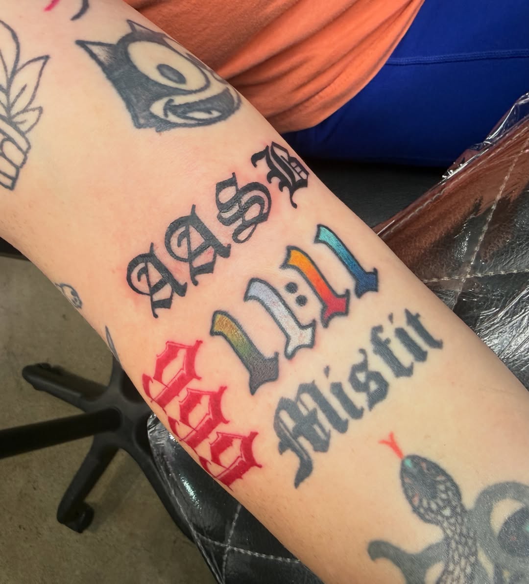Rainbow lettering lettering script tattoo on the forearm by Chloe Peters 🦭🦄🏳️‍🌈