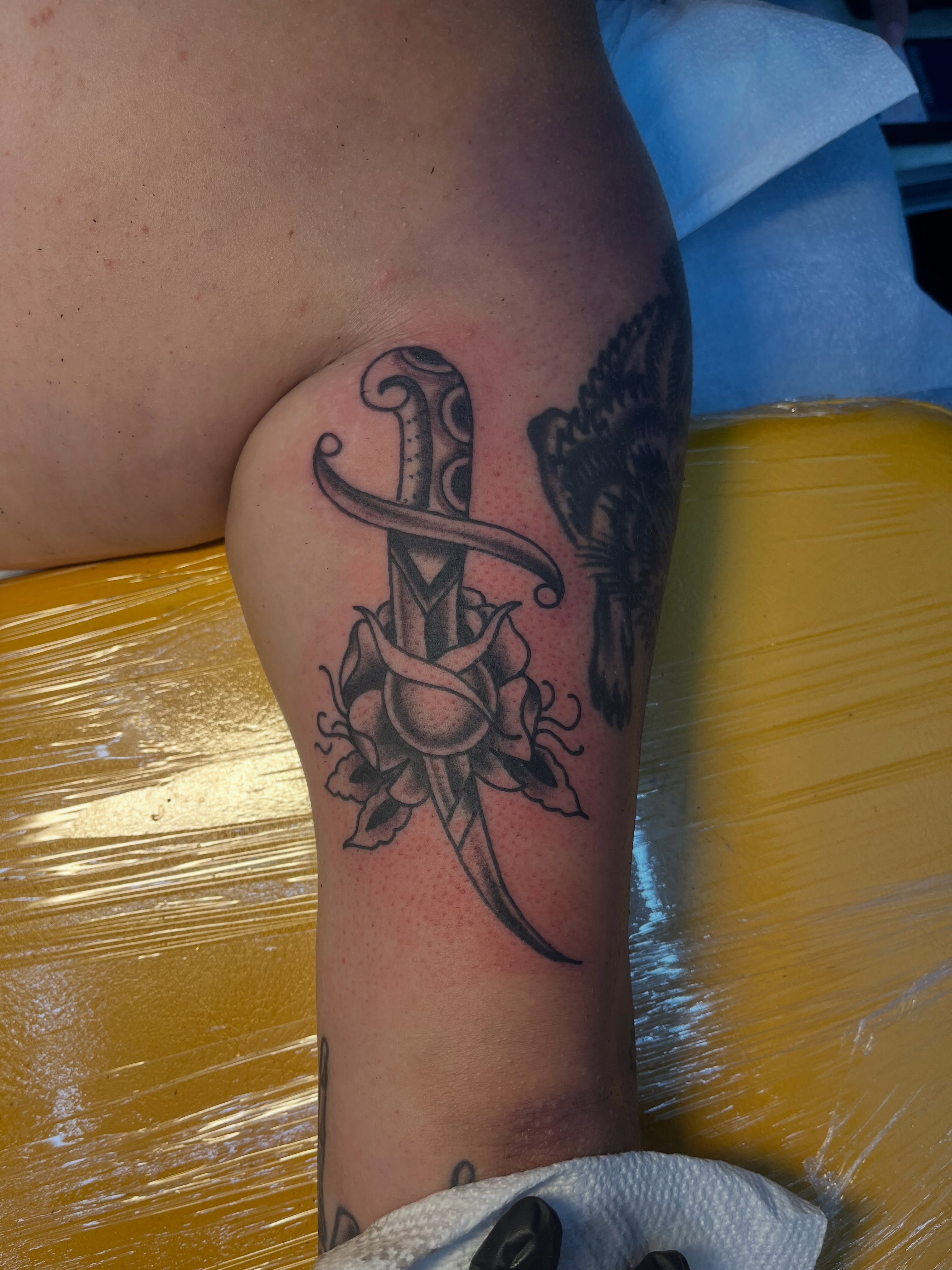 Sword and roses black and grey tattoo on the forearm by Sour Tattoo, Somerville, Massachusetts
