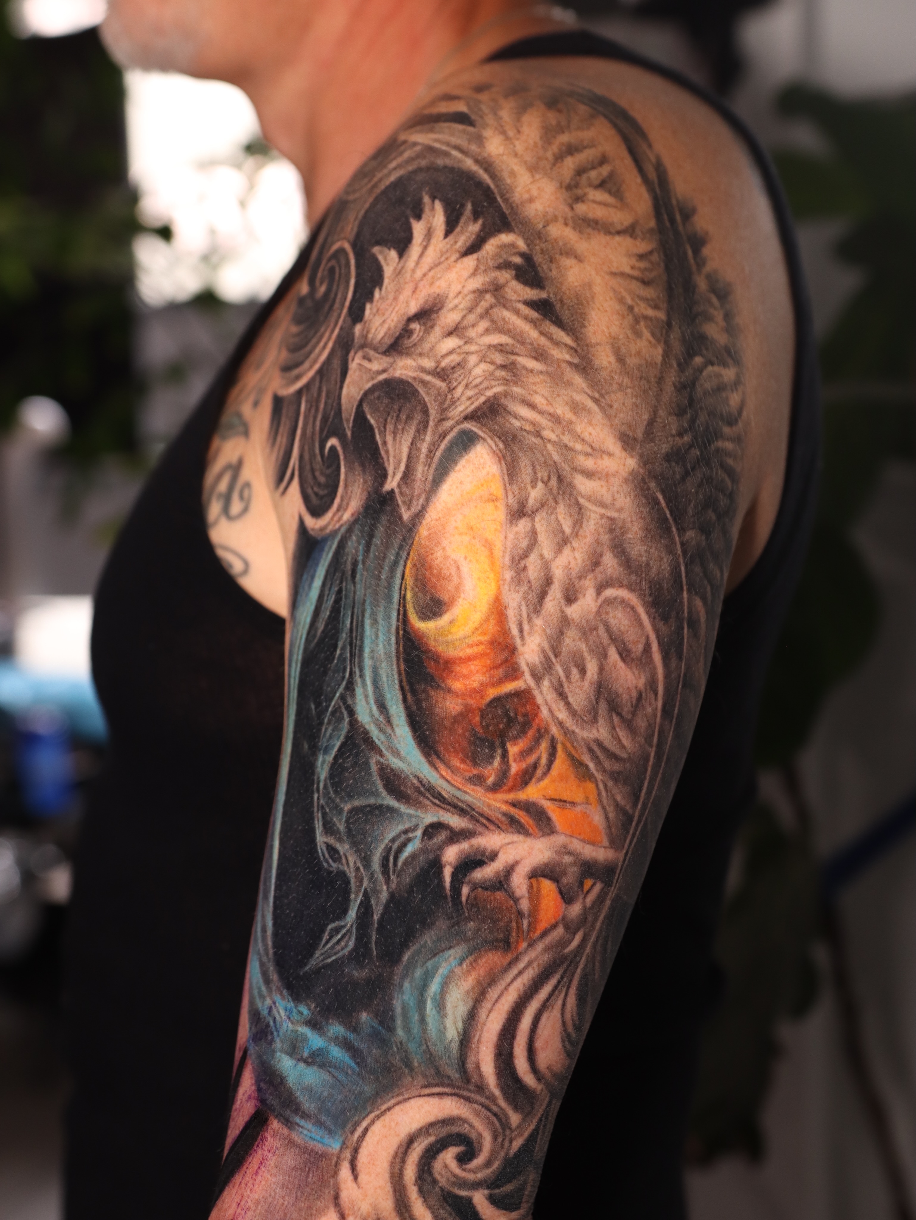 Phoenix realism tattoo on the upper arm by Naomi Burke, New Westminster, British Columbia