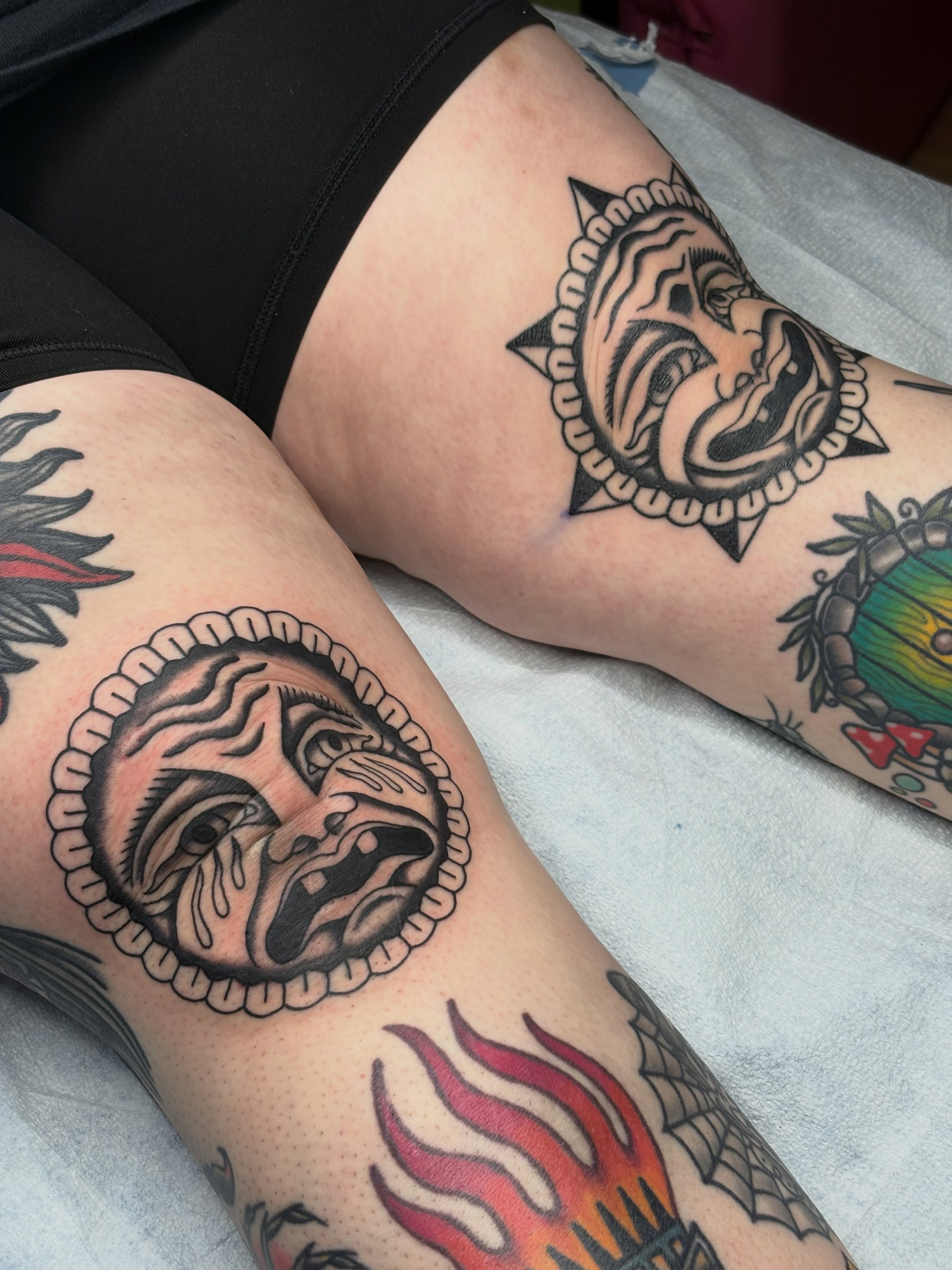 Mask American traditional tattoo on the thigh by Sydney Pflaumer