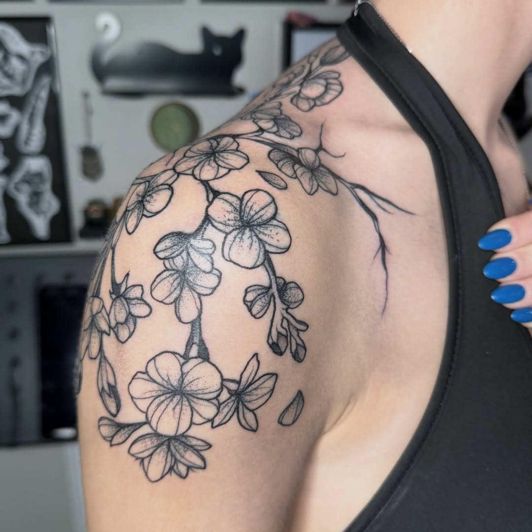 Cherry blossoms black and grey tattoo on the shoulder by Aiden Shaw