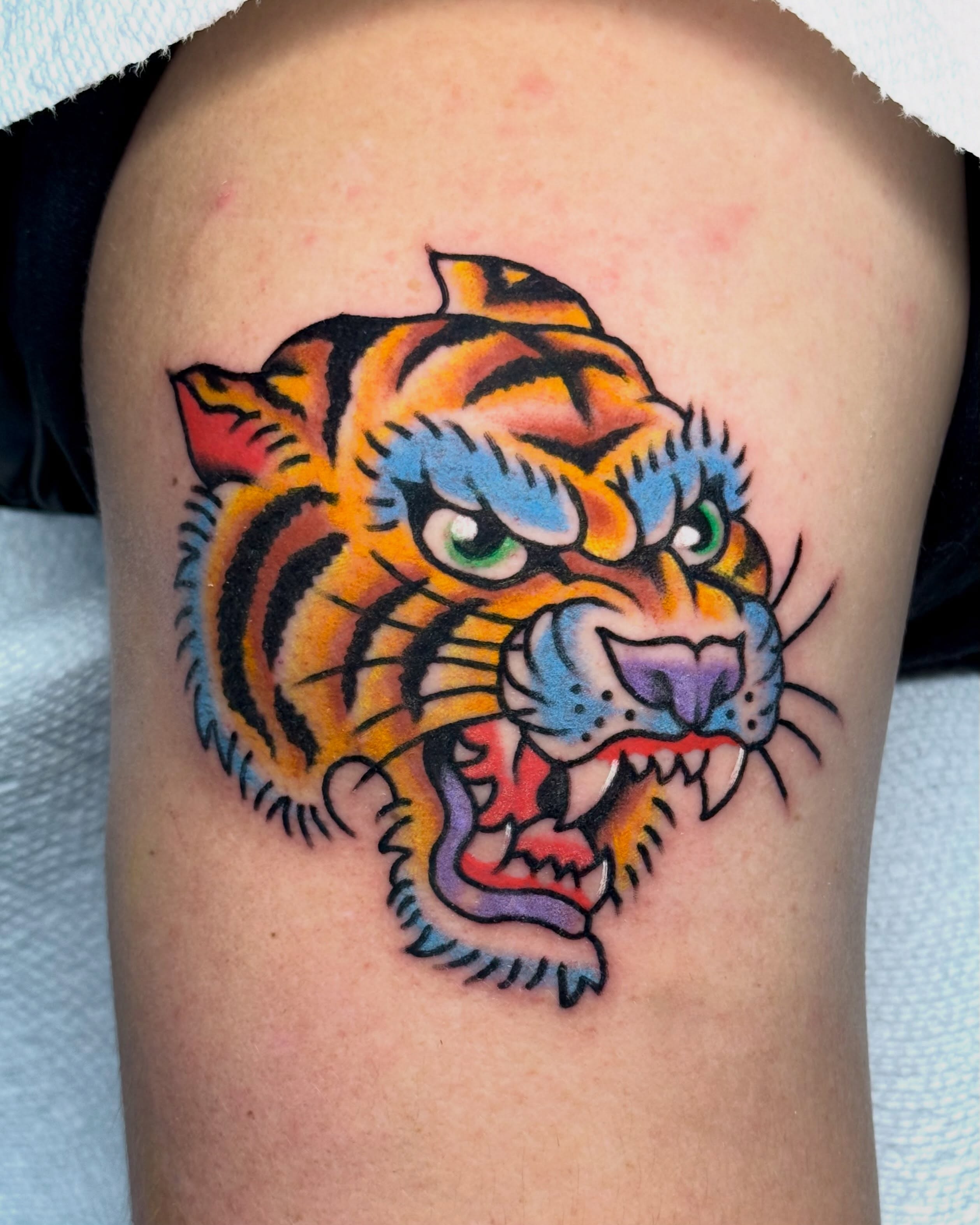 Tiger American traditional tattoo on the thigh by Ty Elias