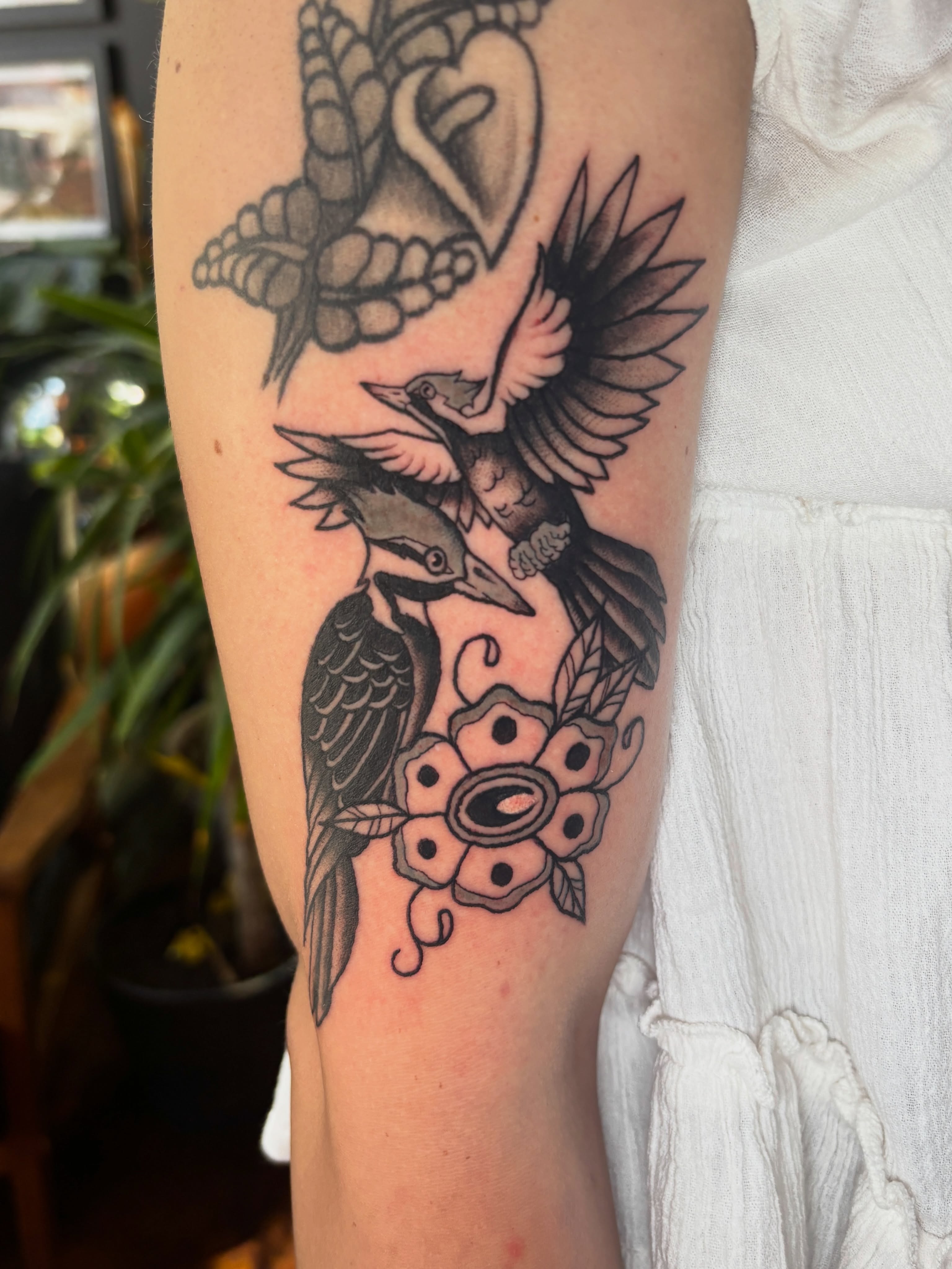 Birds and flower American traditional tattoo on the forearm by Lilly Evans