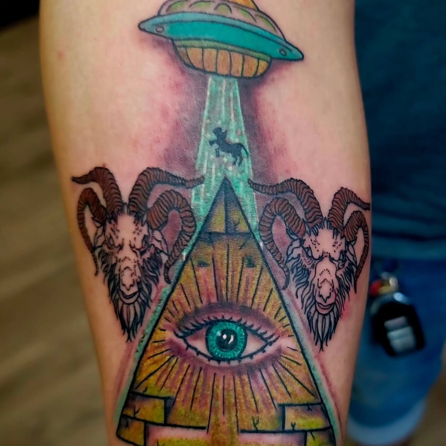 Eye and ram heads geometric tattoo on the forearm by Captain Michael Devious