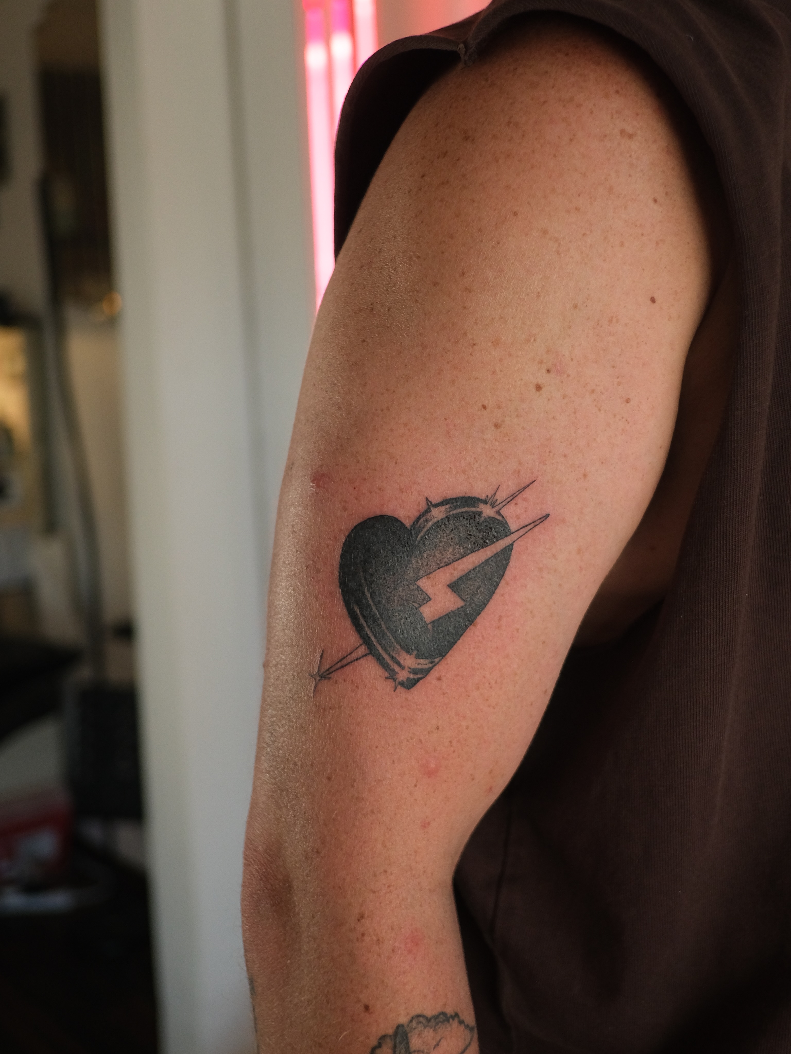 Heart with lightning bolt black and grey tattoo on the forearm by Zanereti