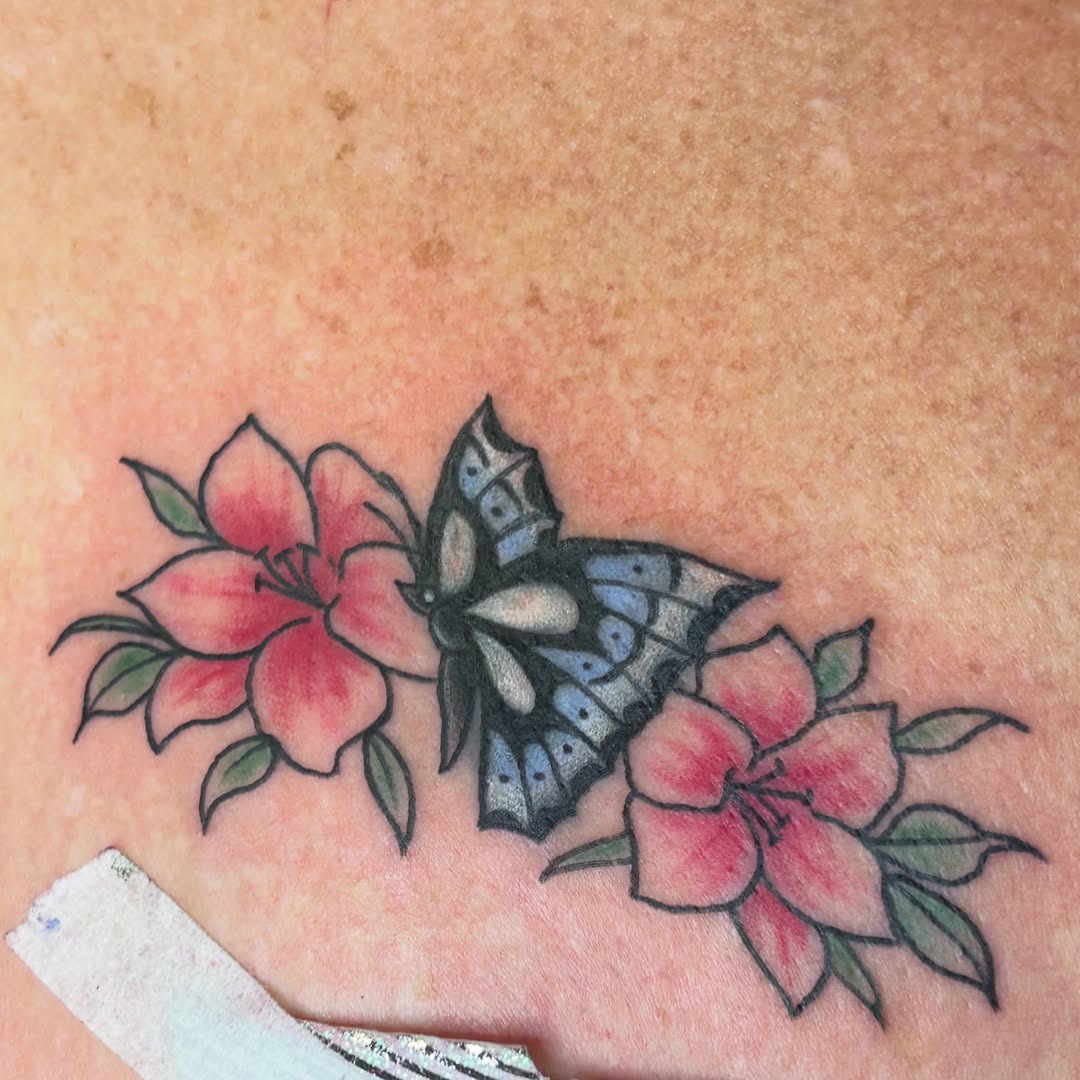 Butterfly and flowers American traditional tattoo on the torso by Gabby, Kansas City, Missouri
