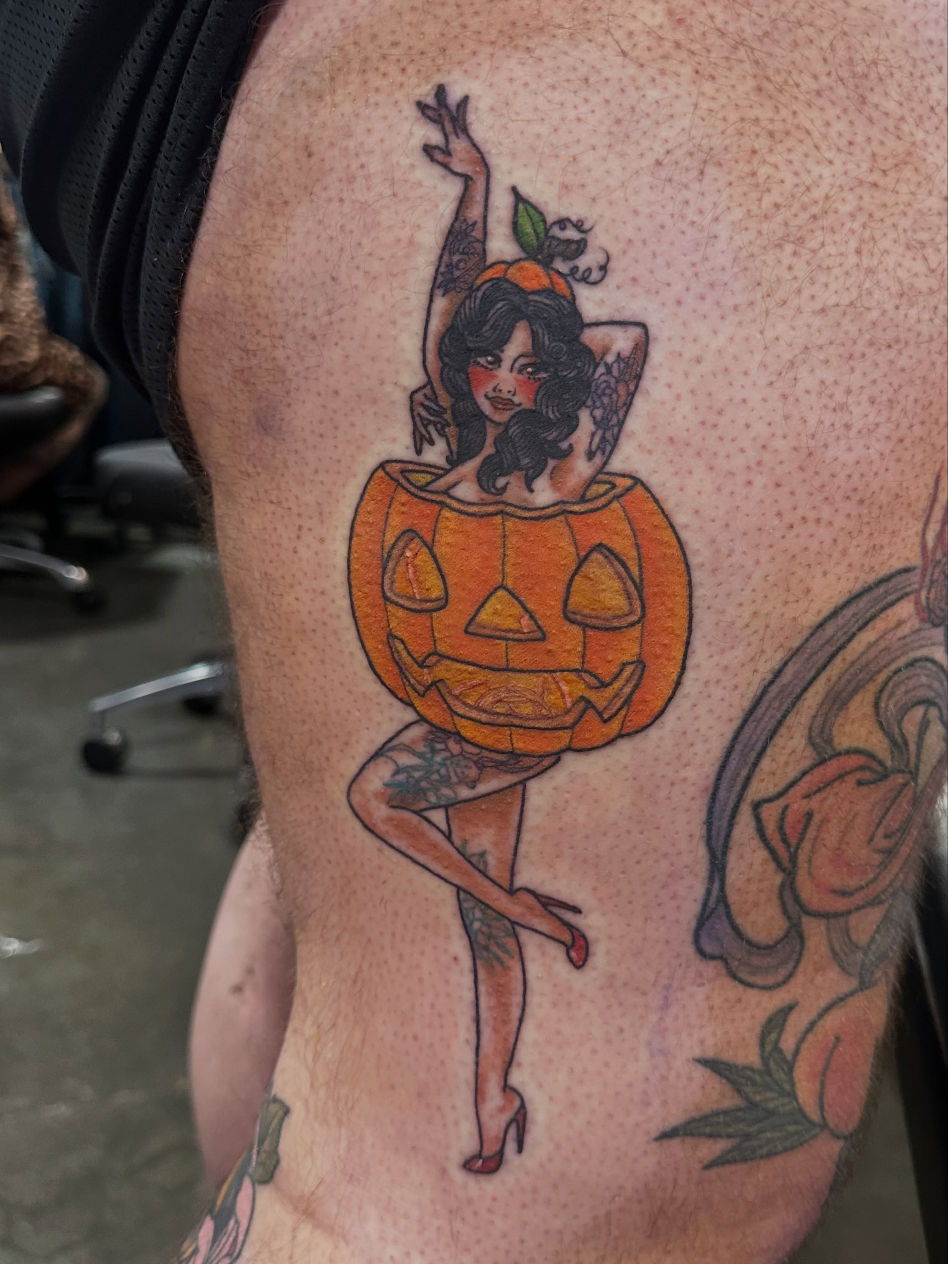 Pumpkin-headed woman American traditional tattoo on the thigh by Erin Miller