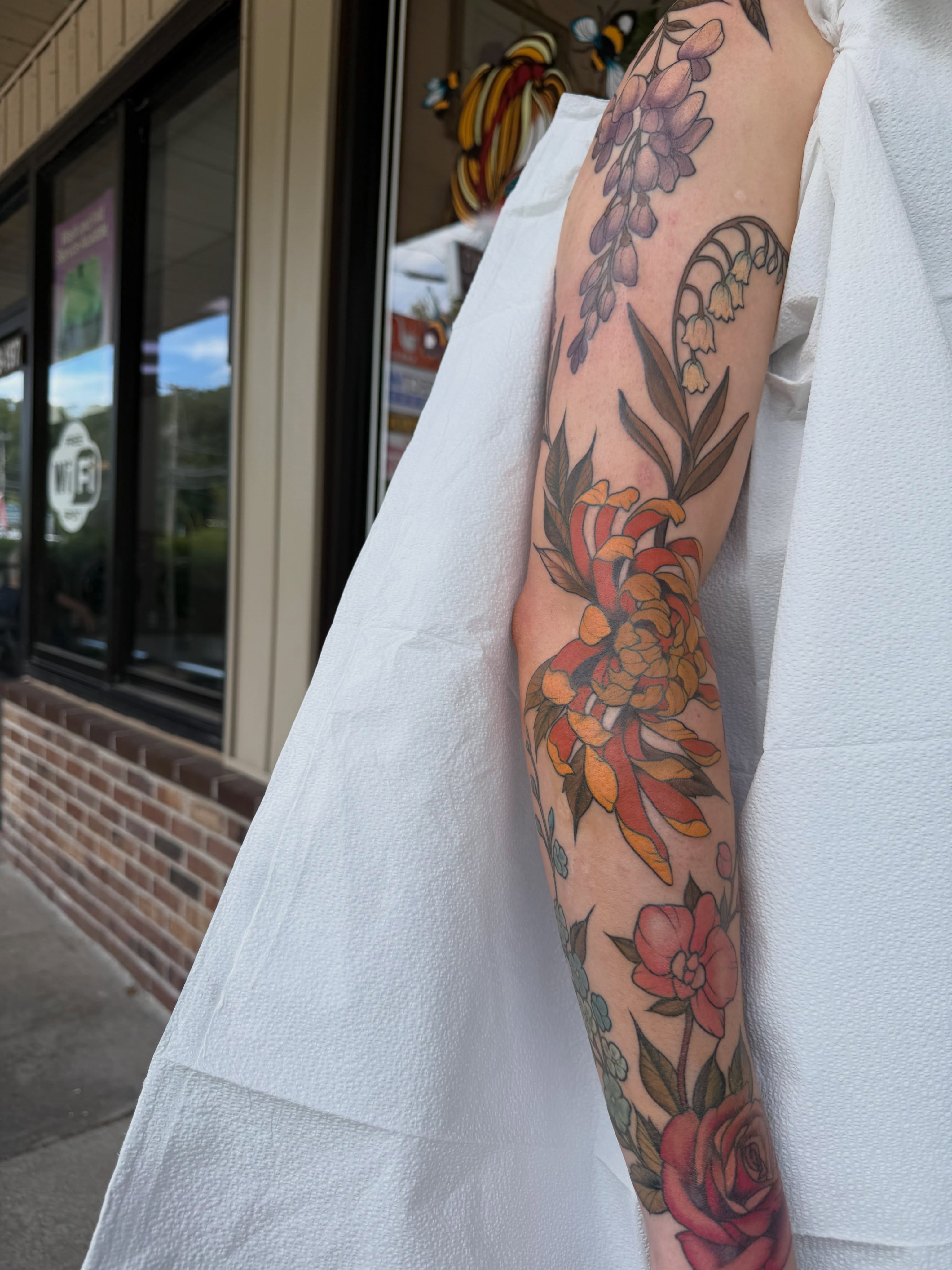 Floral arrangement new school tattoo on the forearm by Mikaila Rose Krauss