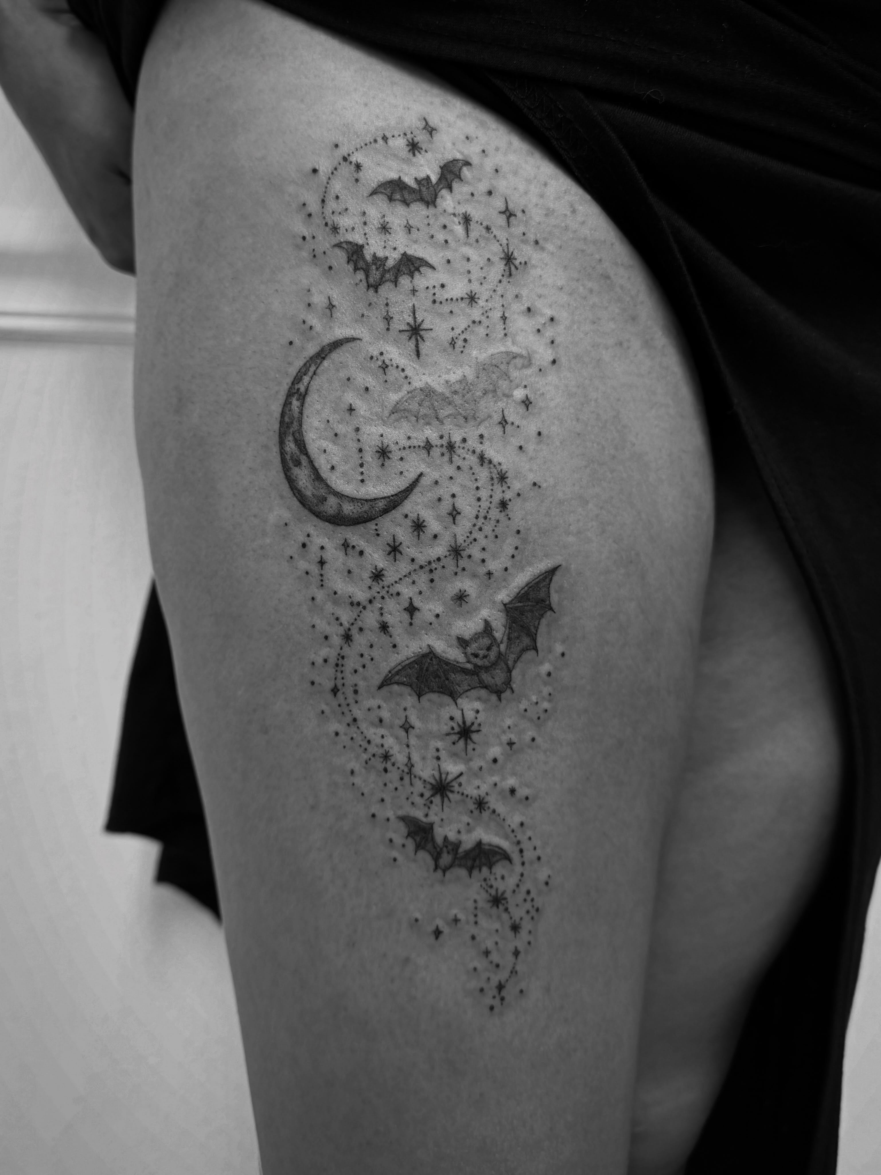 Bats and stars dotwork tattoo on the thigh by Taylor Johnson