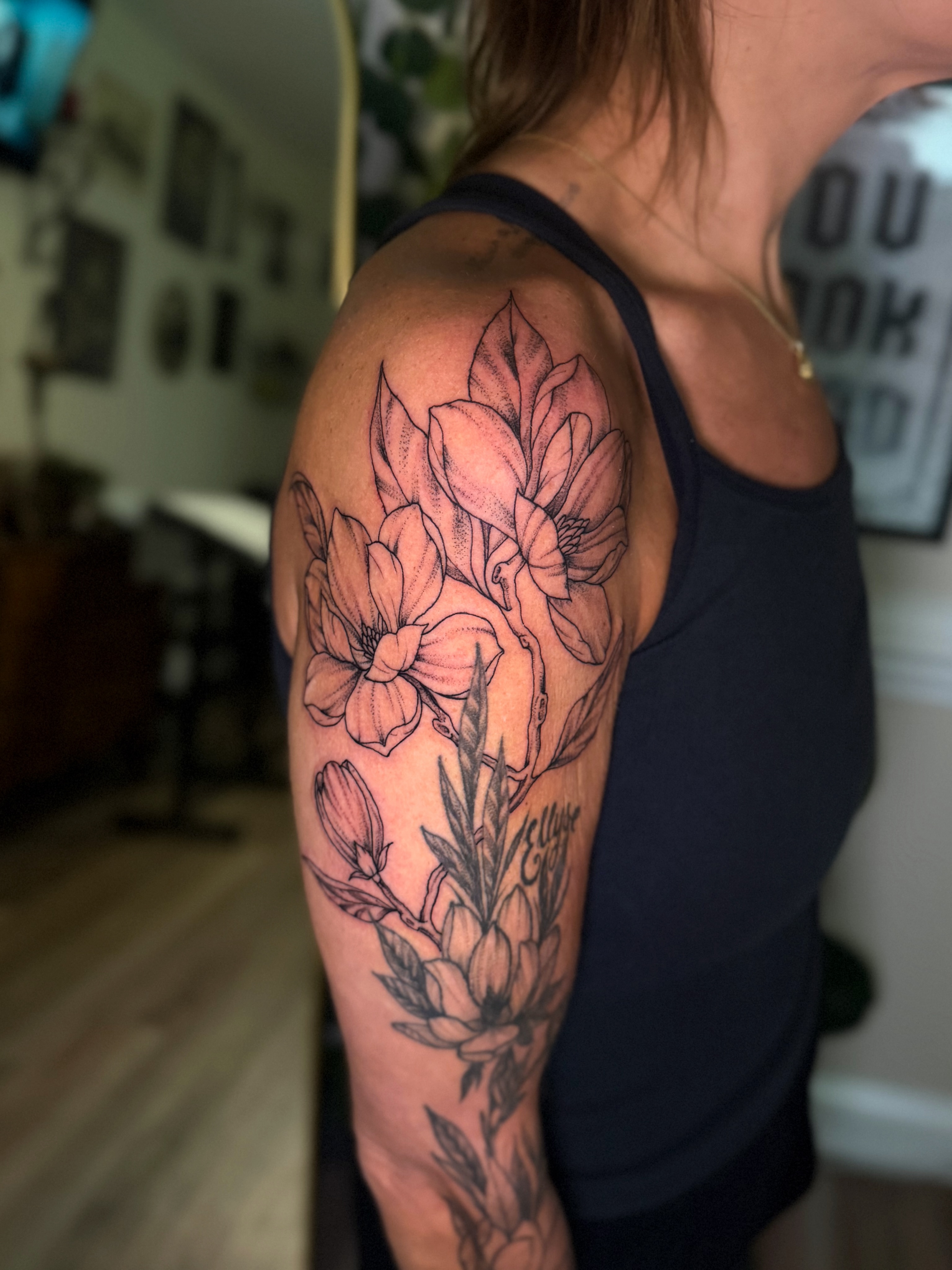 Flowers dotwork tattoo on the upper arm by McKenna