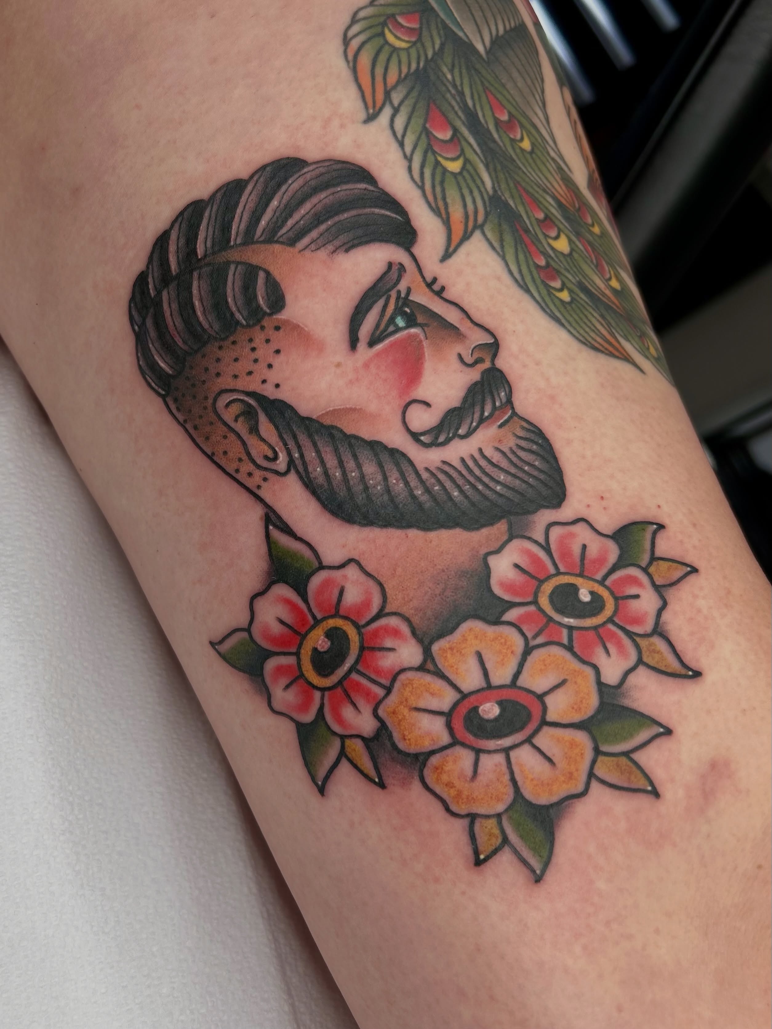 Man with mustache American traditional tattoo on the thigh by Noah Crow