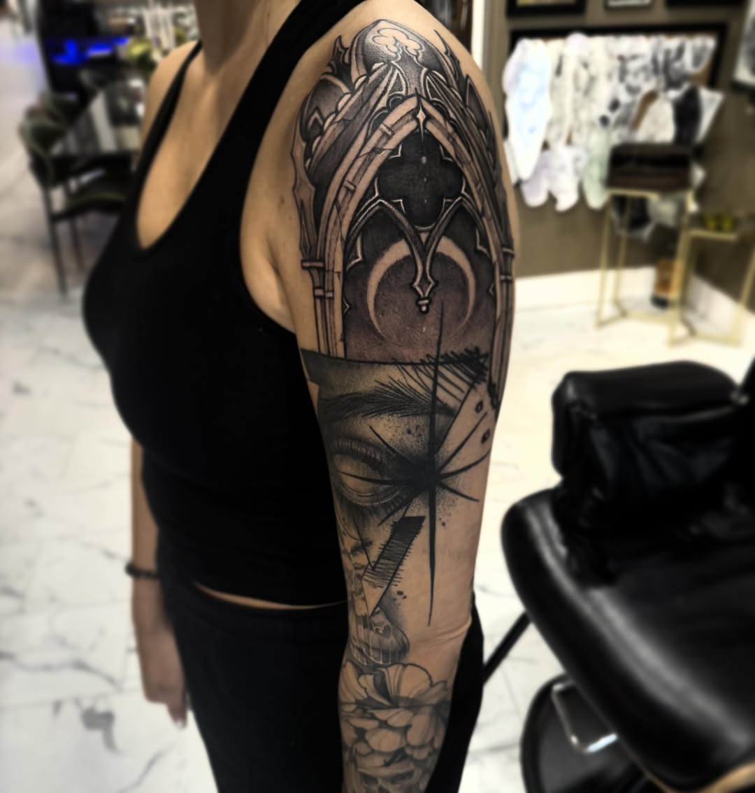 Gothic arch geometric tattoo on the upper arm by Keith Smith