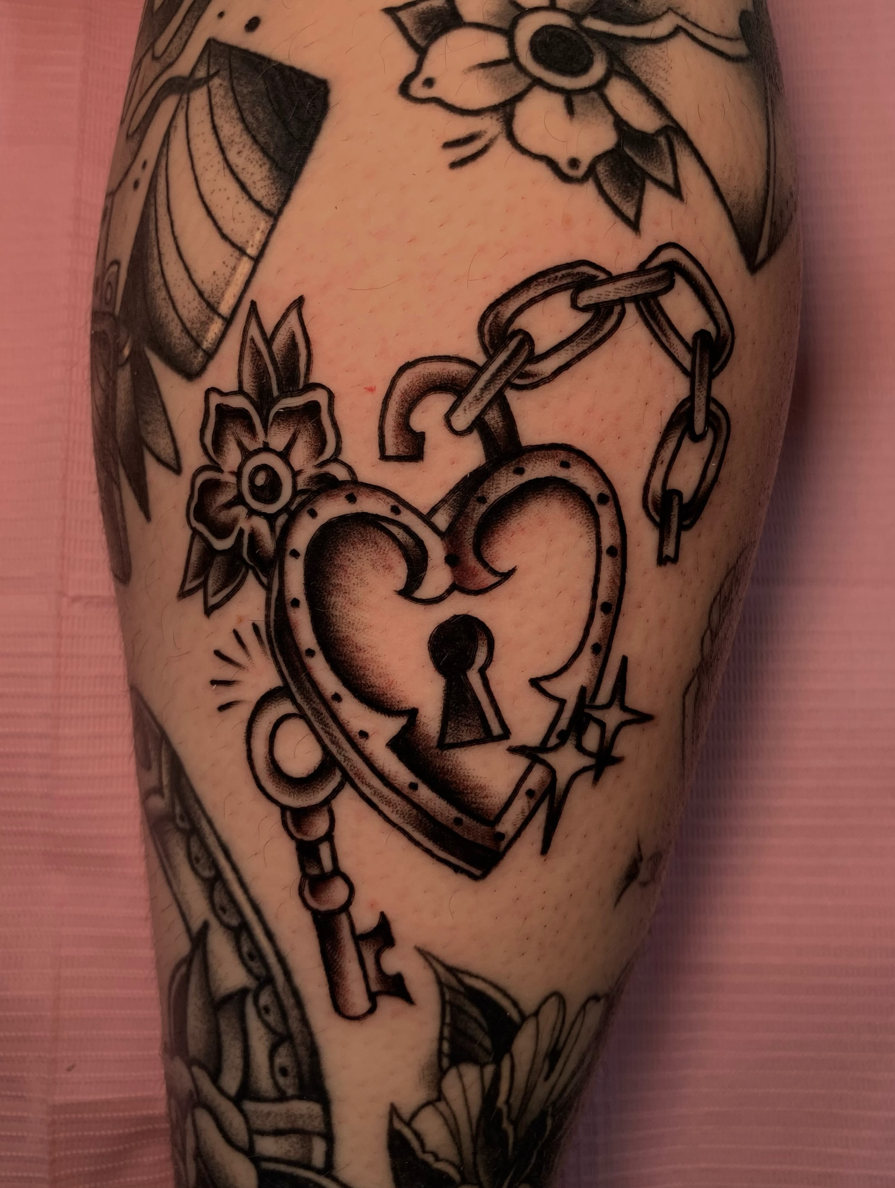Heart lock American traditional tattoo on the forearm by Aubrianna Grisez