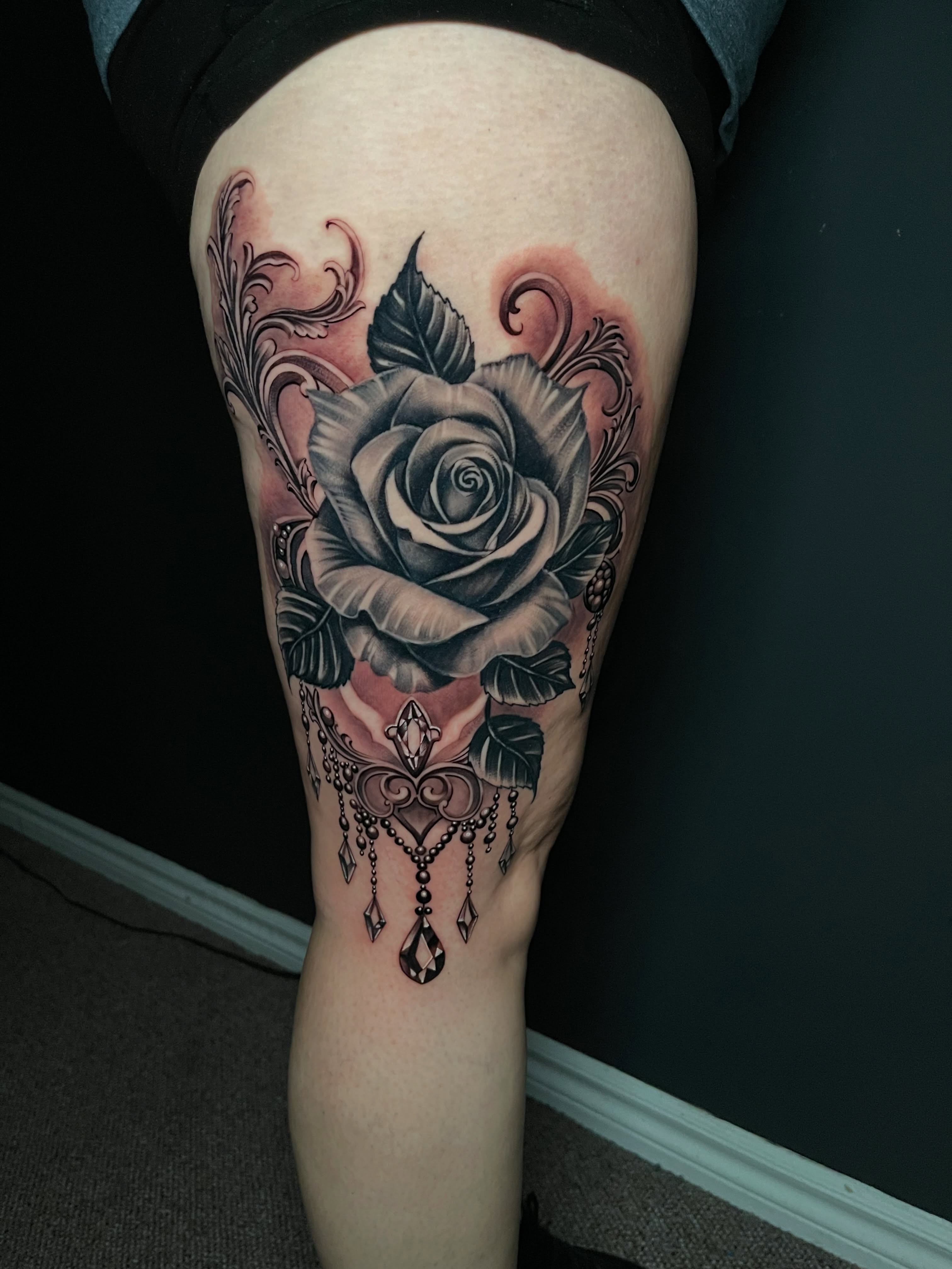 Rose realism tattoo on the thigh by Michael Martinez