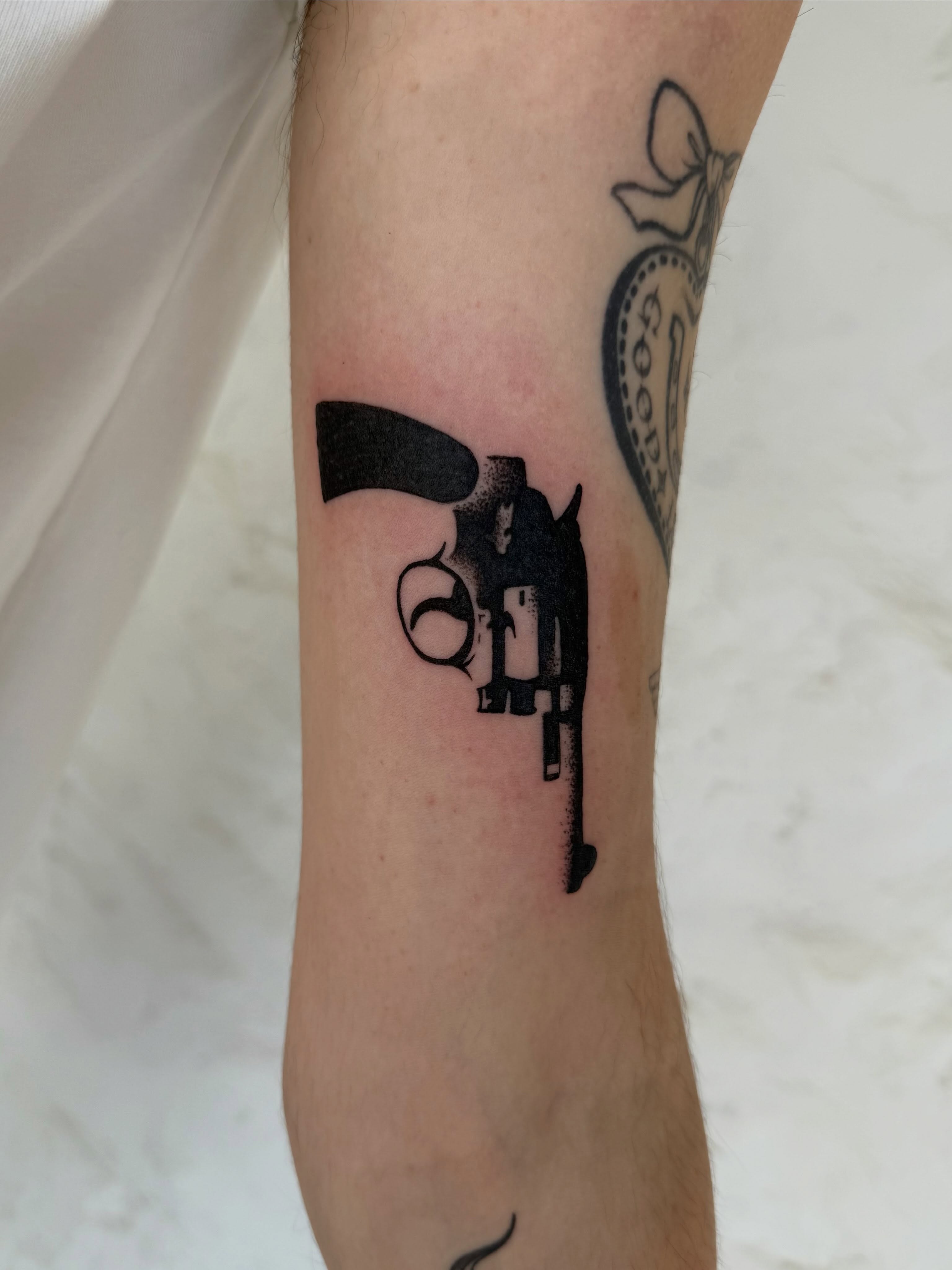 Revolver dotwork tattoo on the forearm by sarah