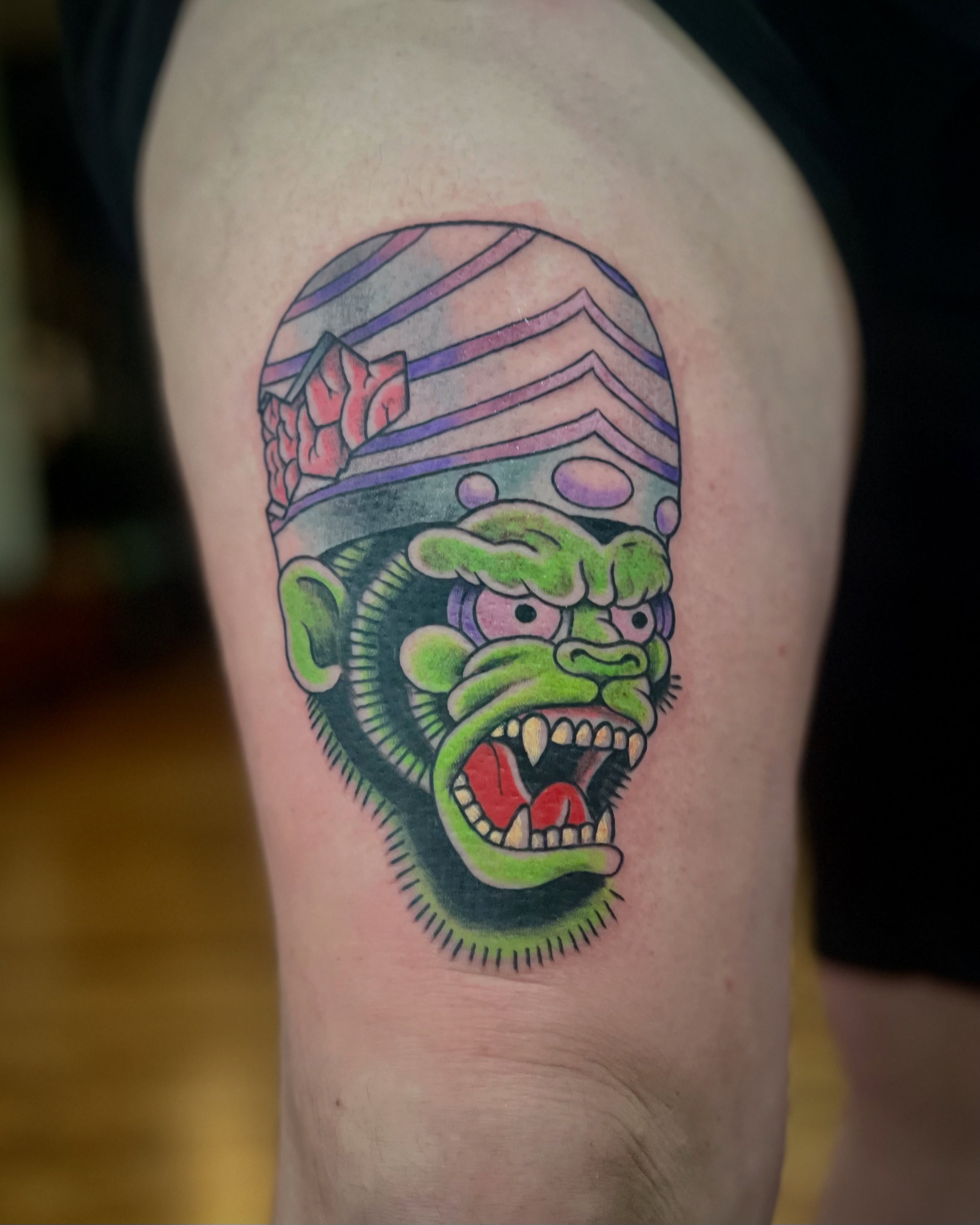 Green monkey American traditional tattoo on the thigh by EO, Chicago, Illinois