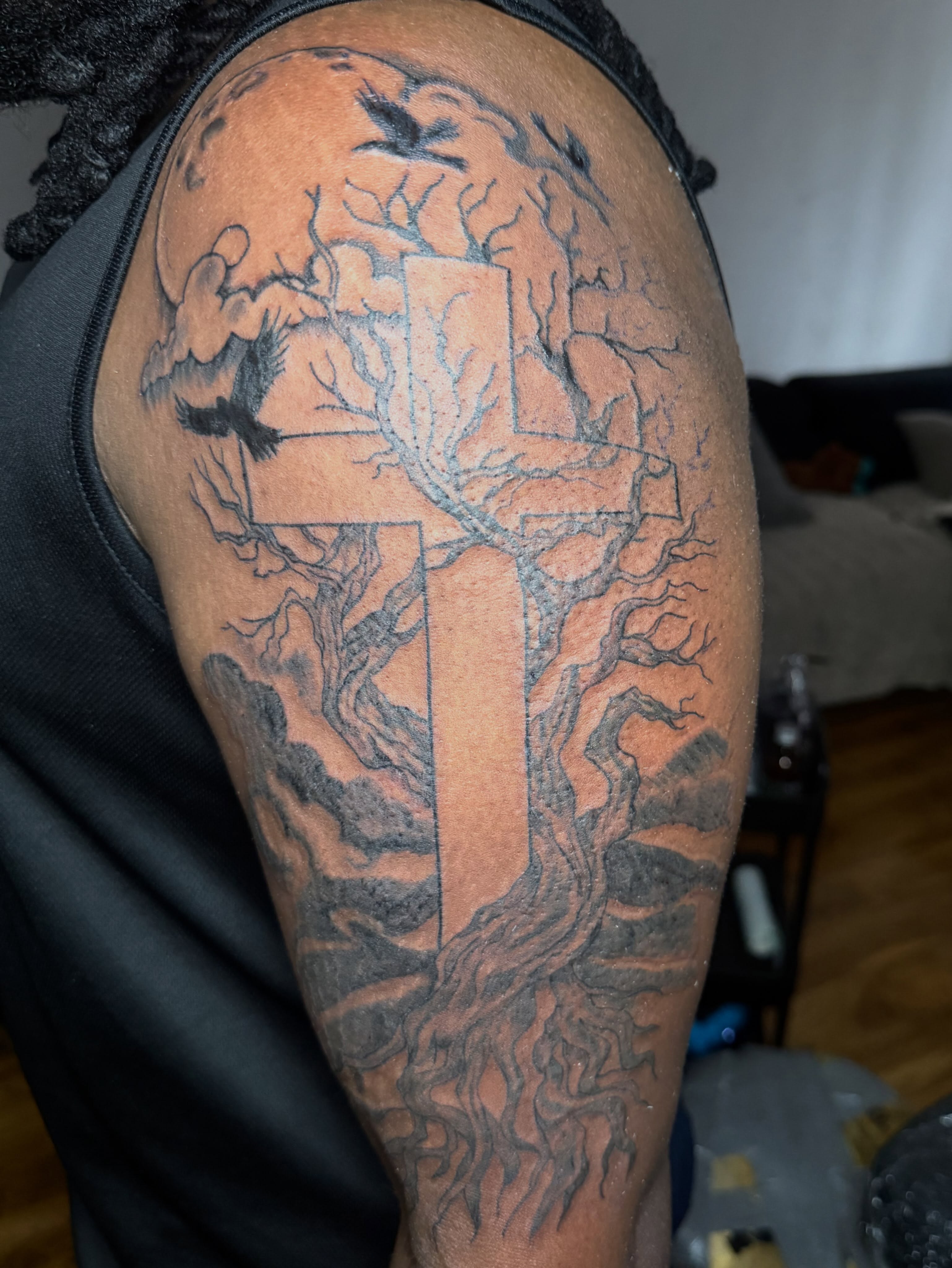 Cross and tree black and grey tattoo on the shoulder by Tcstatts