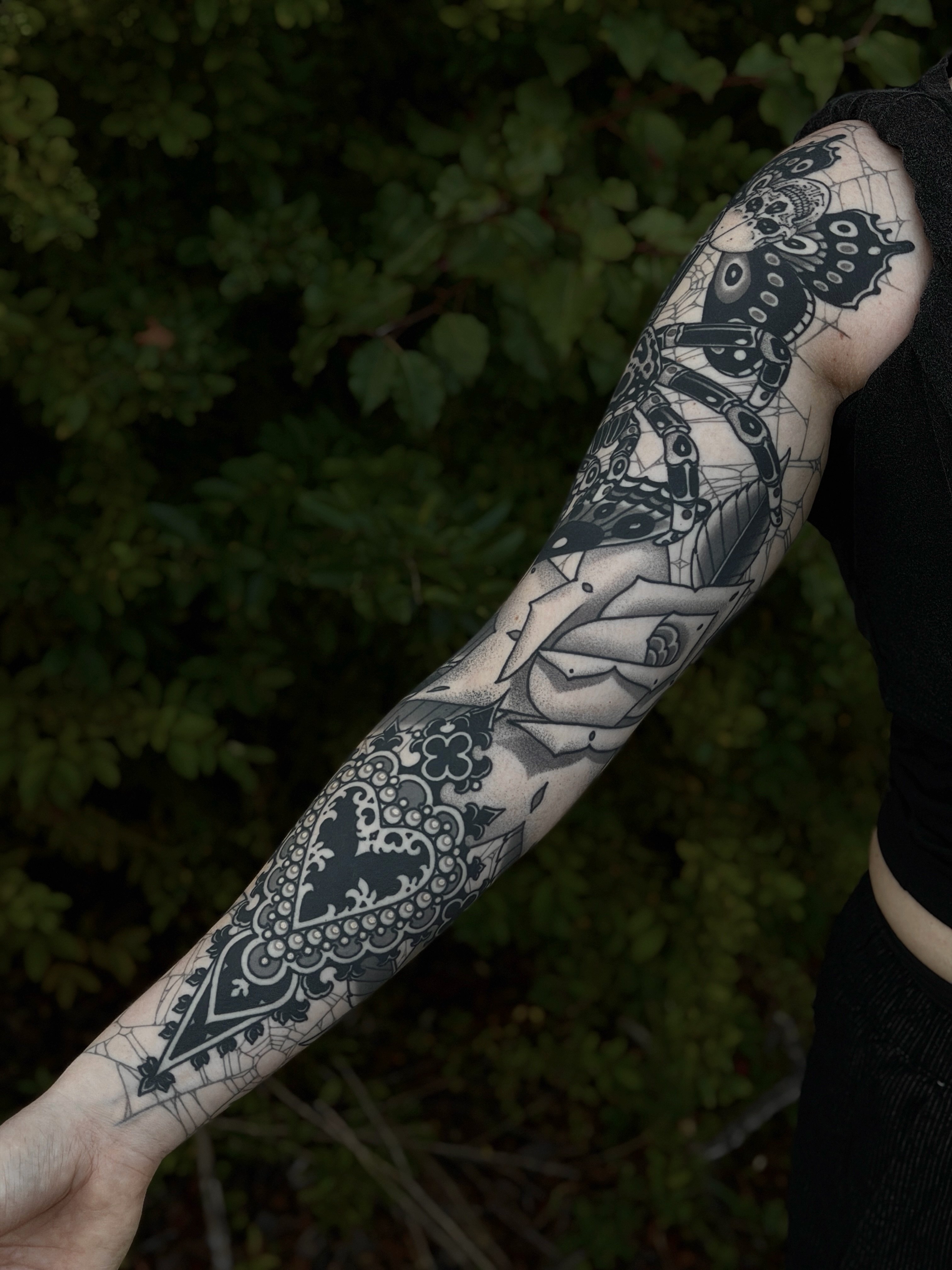 Butterfly and floral geometric tattoo on the forearm by Tyler Charles