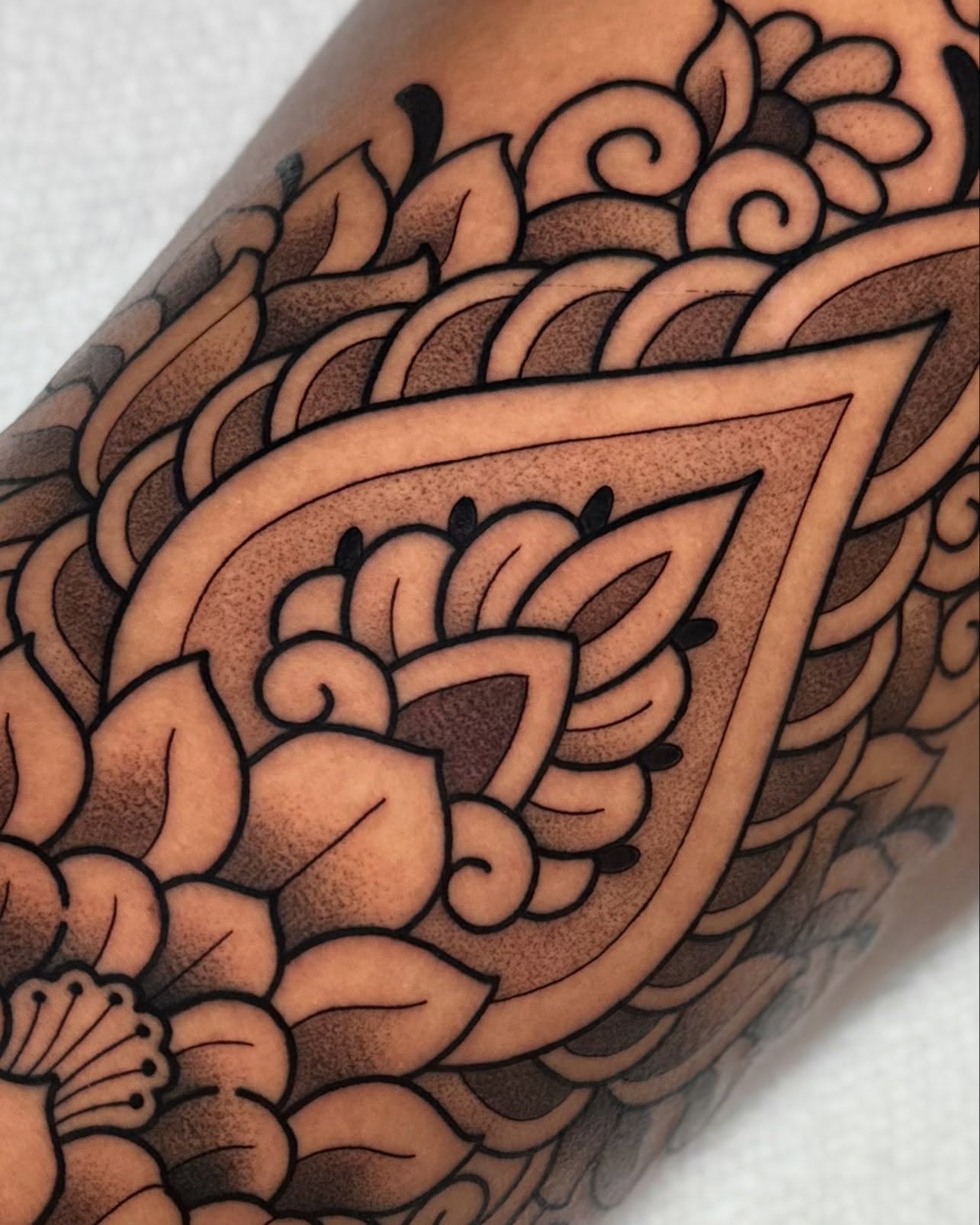 Floral pattern black and grey tattoo on the forearm by Bell Bolton