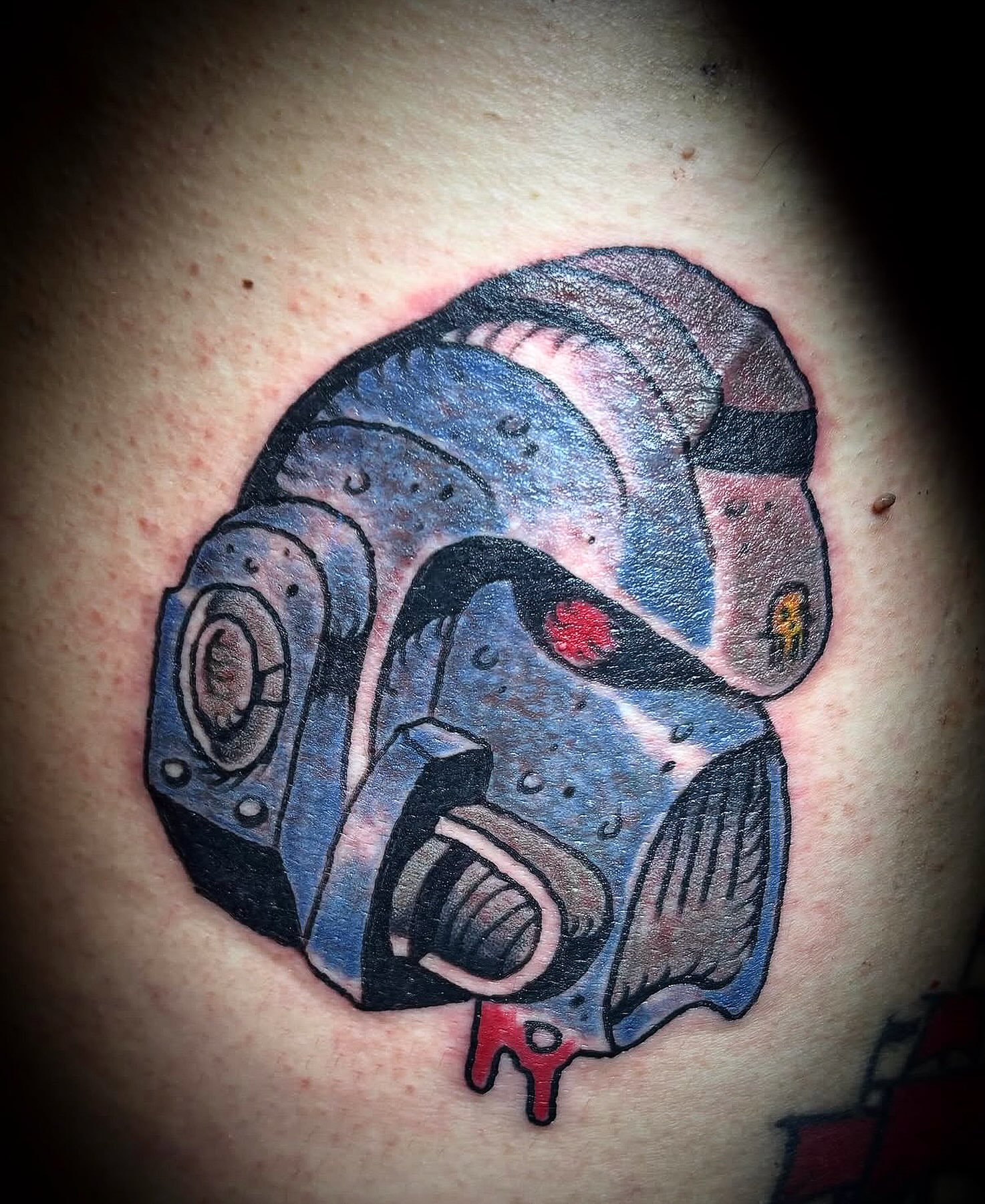 Mecha helmet geometric tattoo on the chest by Visionary Tattoos