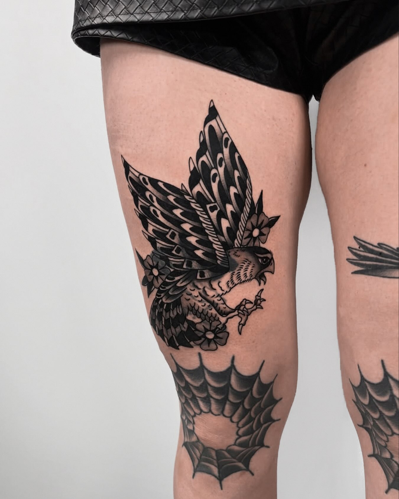 Falcon black and grey tattoo on the thigh by Lorelei