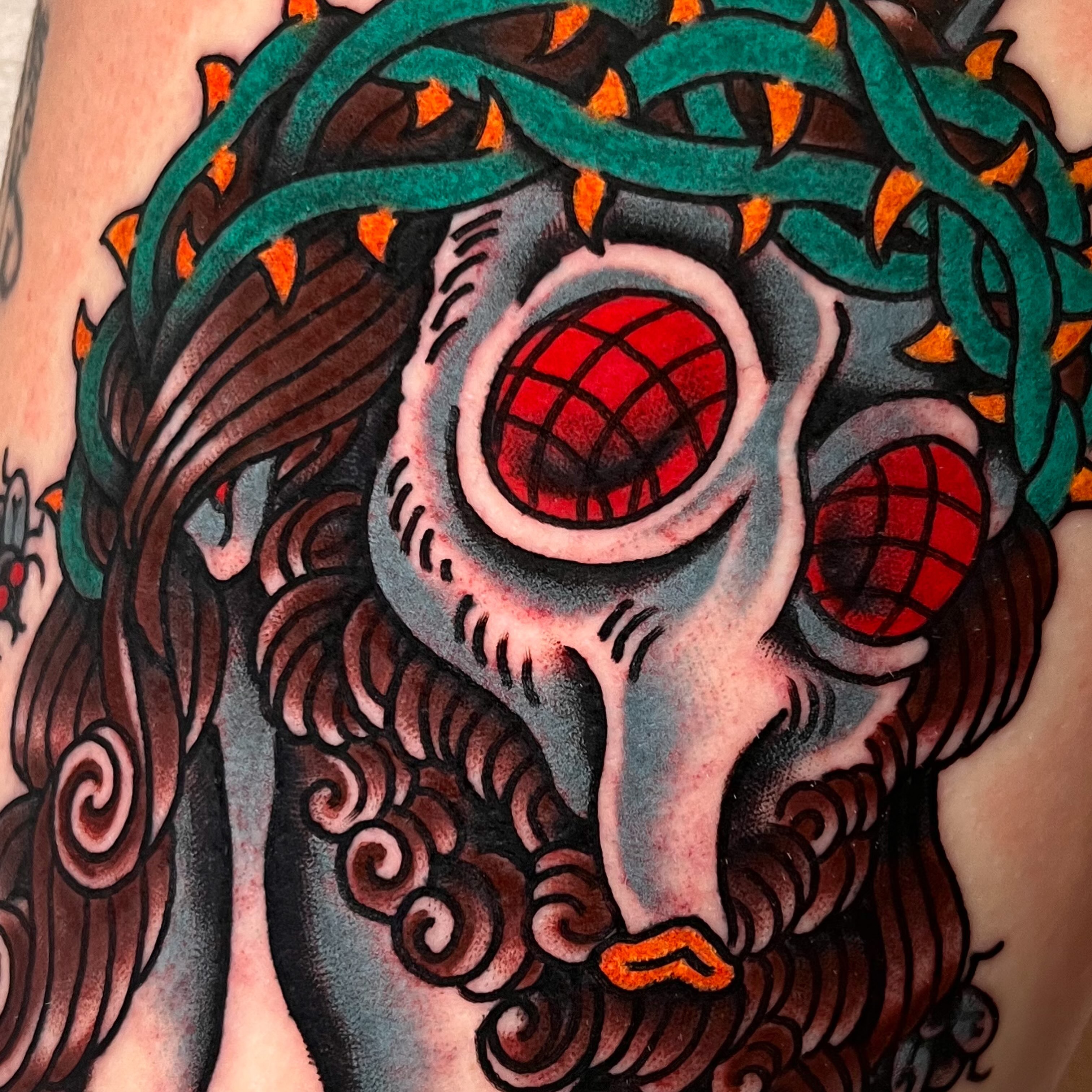 Skull with red eyes American traditional tattoo on the thigh by Sky G, Colorado Springs, Colorado